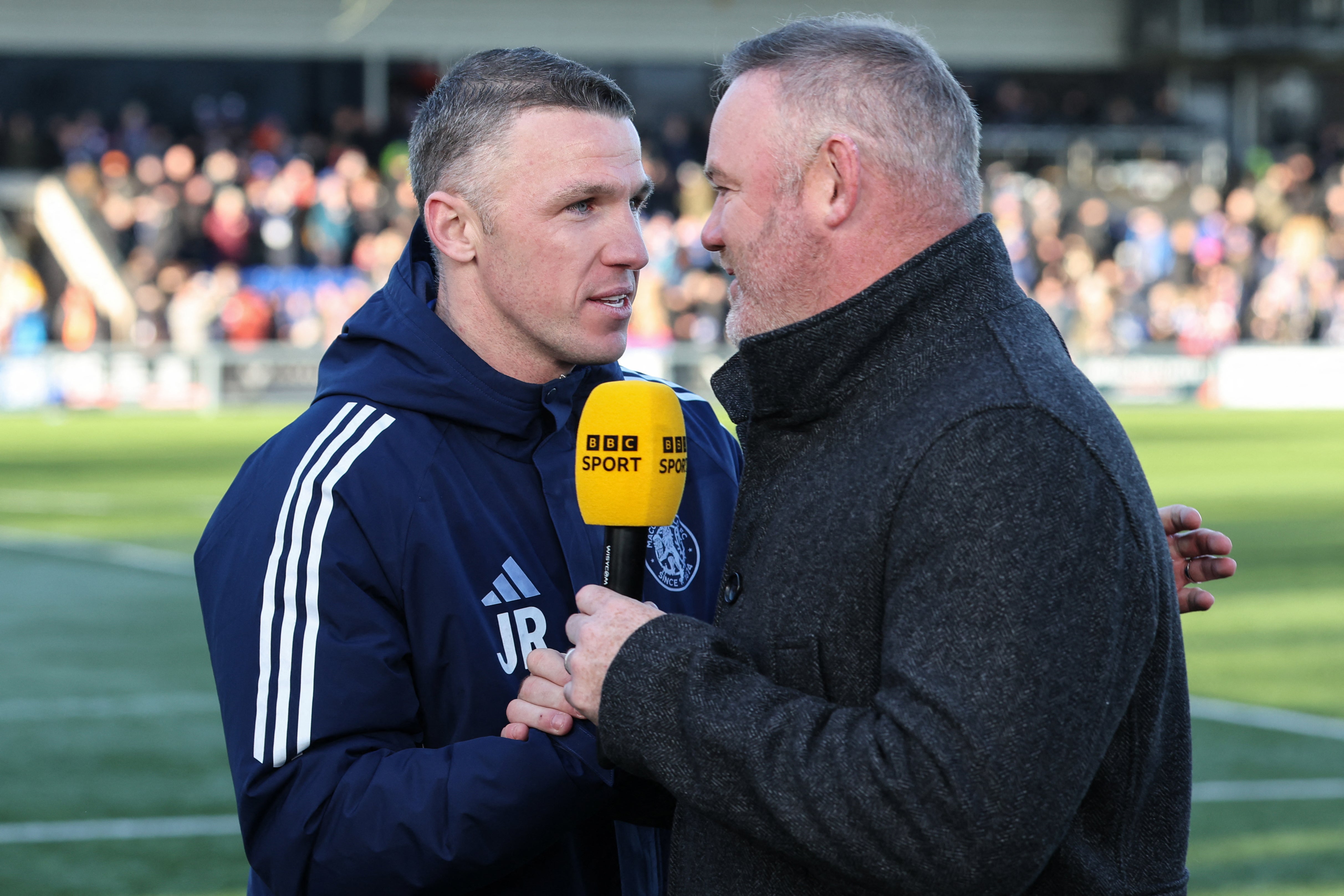 O técnico do Macclesfield, John Rooney, foi entrevistado por seu irmão, o ex-astro da Inglaterra Wayne Rooney