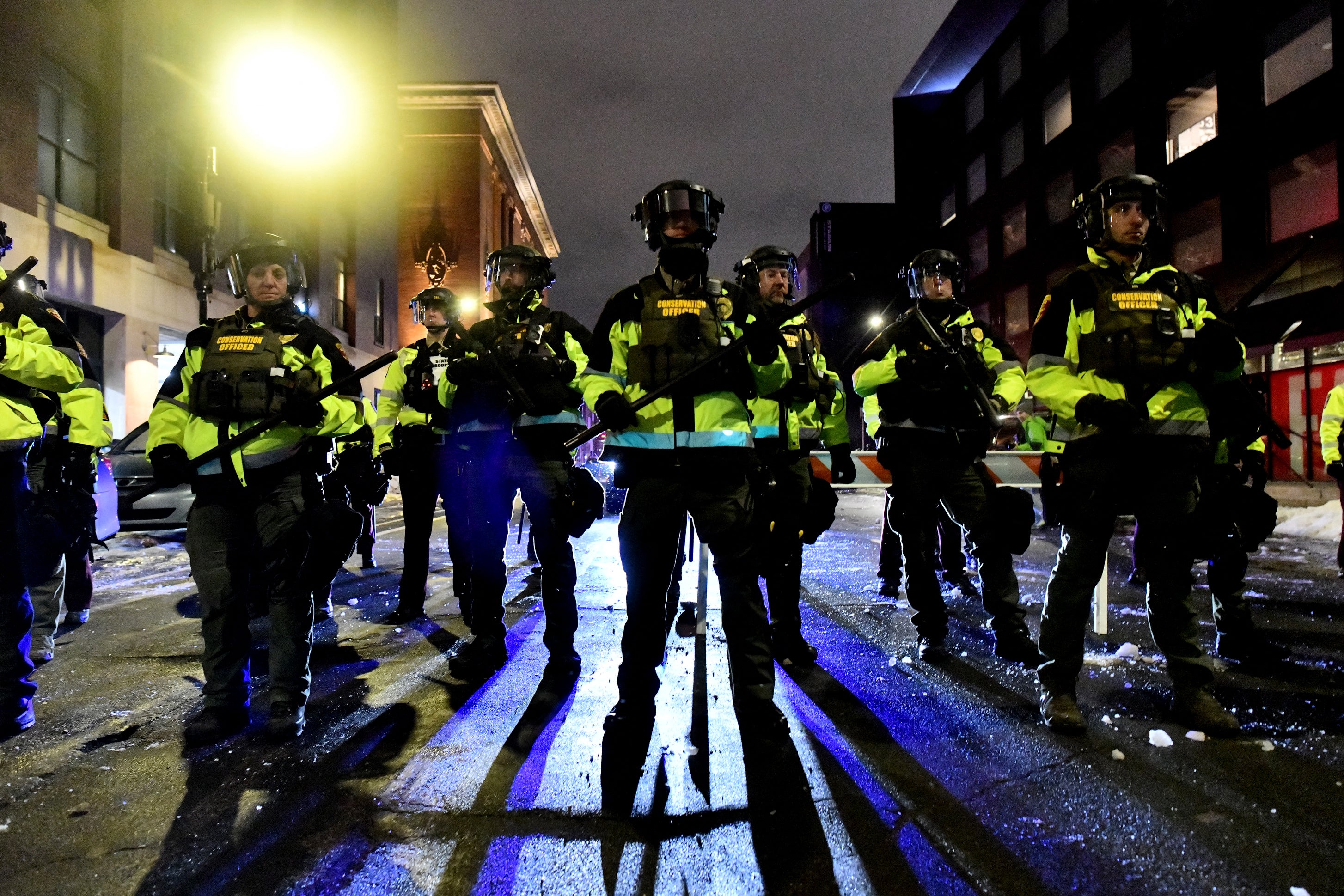 Minnesota Conservation Officers stand in formation as protesters were given the order to disperse after marching in protest against ICE