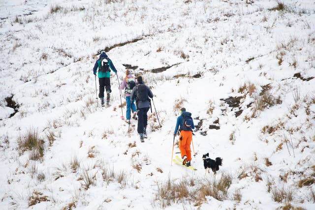 People walking on Pen y Fan in the Bannau Brycheiniog National Park(Ben Birchall/PA)