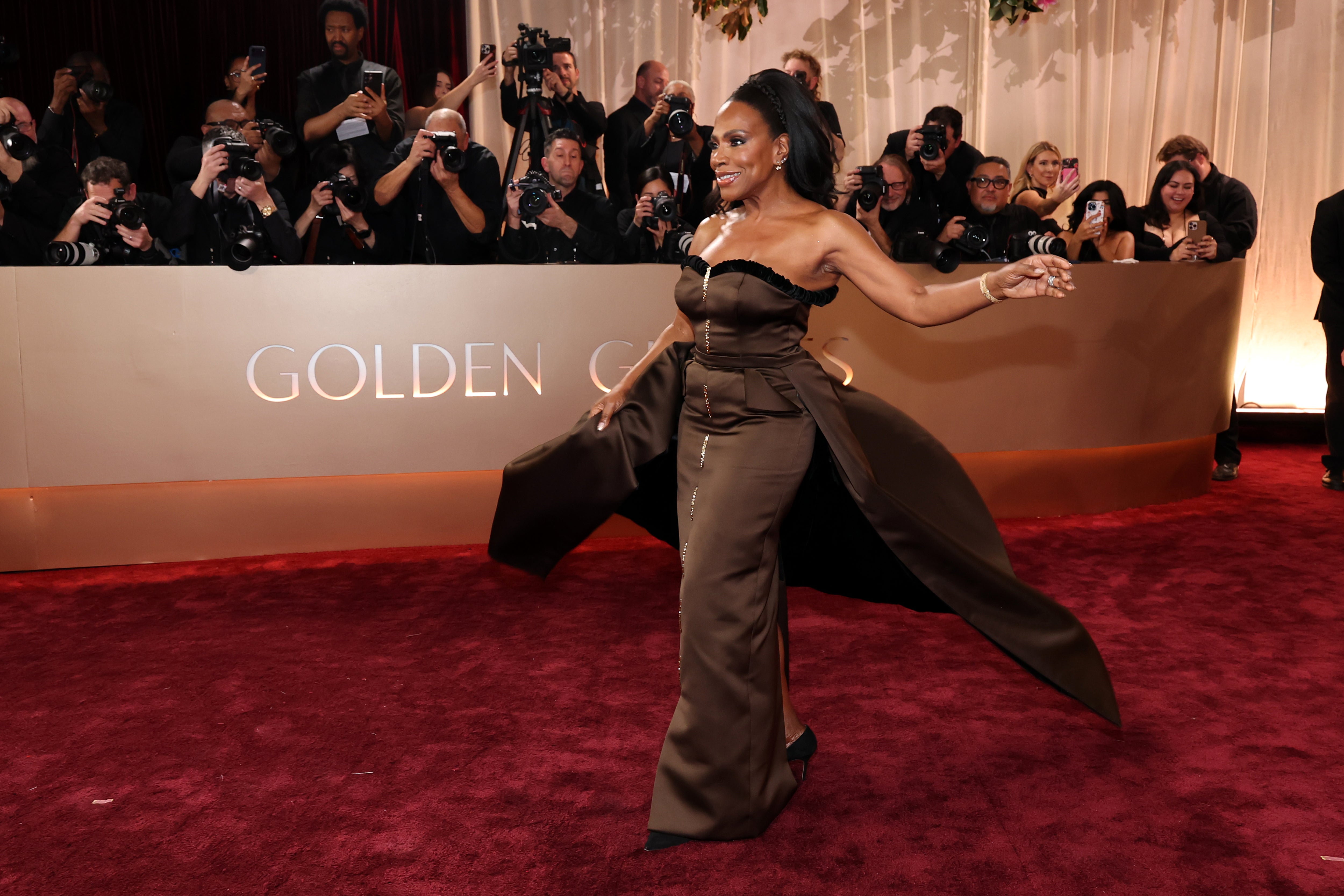 Sheryl Lee Ralph appeared in a brown strapless Harbison Studio gown adorned with black trim, but the gold sequin trail running down the middle of the gown looked like an awkward zipper
