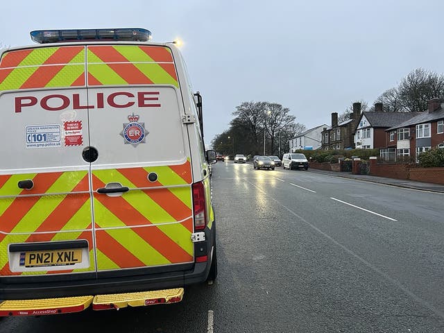 <p>Police near the scene where a Seat Leon collided with a Citroen C4 Picasso taxi on Wigan Road in Bolton </p>