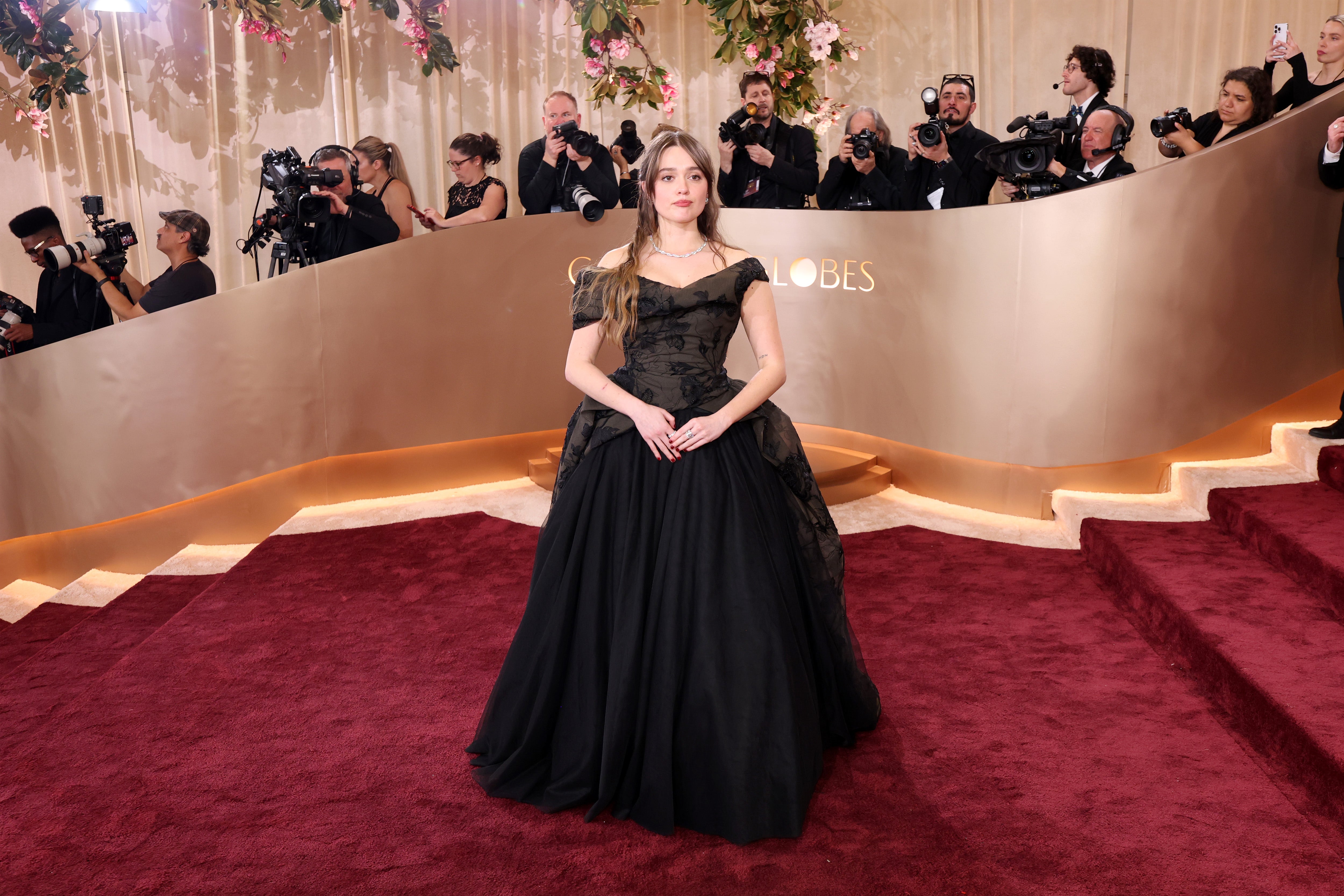 Aimee Lou Wood wore a black off-the-shoulder gown to the awards show with a too-full skirt that looked like it was swallowing her body