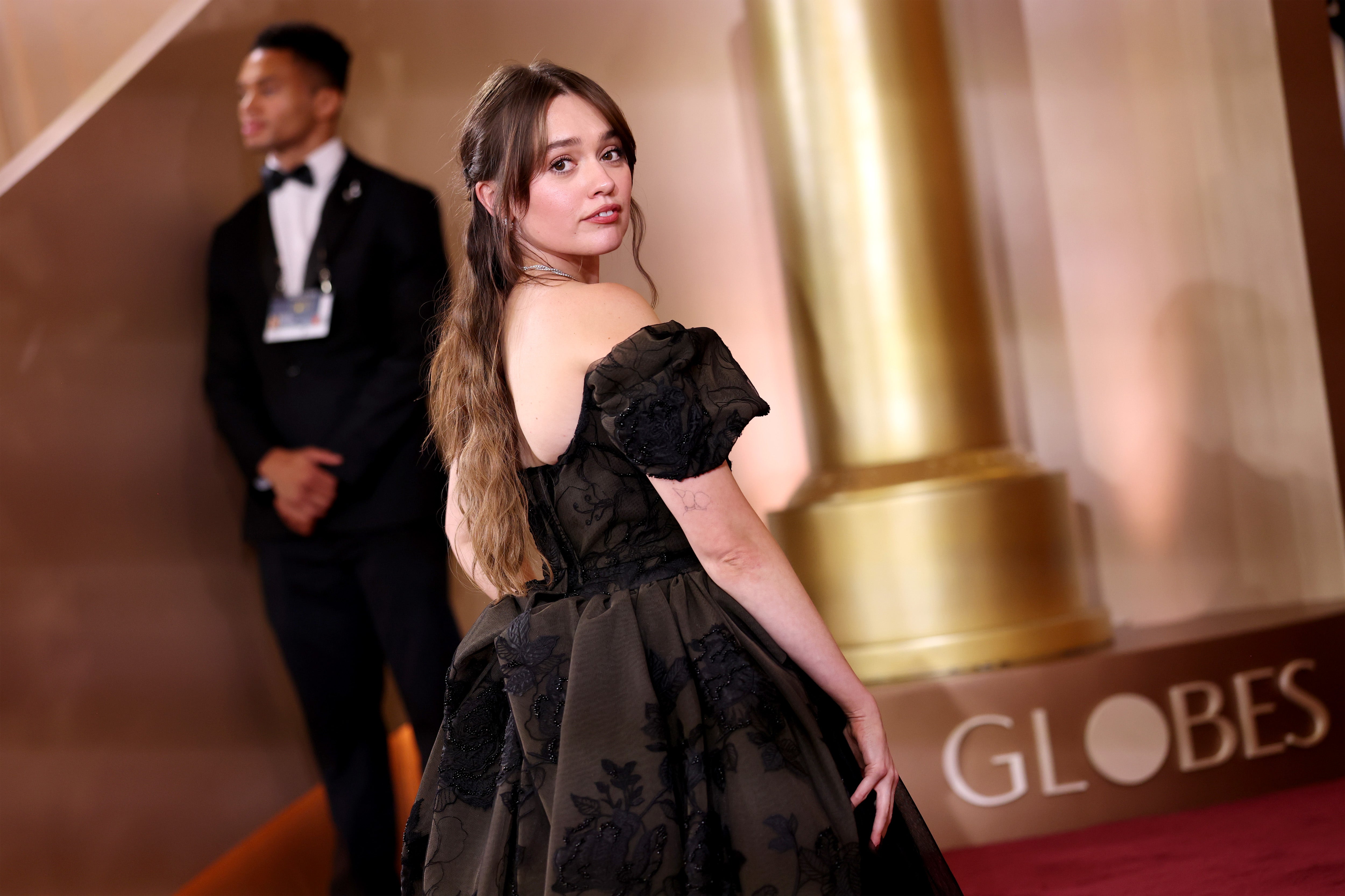 Wood, nominated for her very first Golden Globe for her role on ‘The White Lotus,’ wore her hair curled in a half-up, half-down style