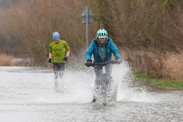 Melting snow and ice along with heavy rain may cause flooding, the Met Office said (Joe Giddens/PA)