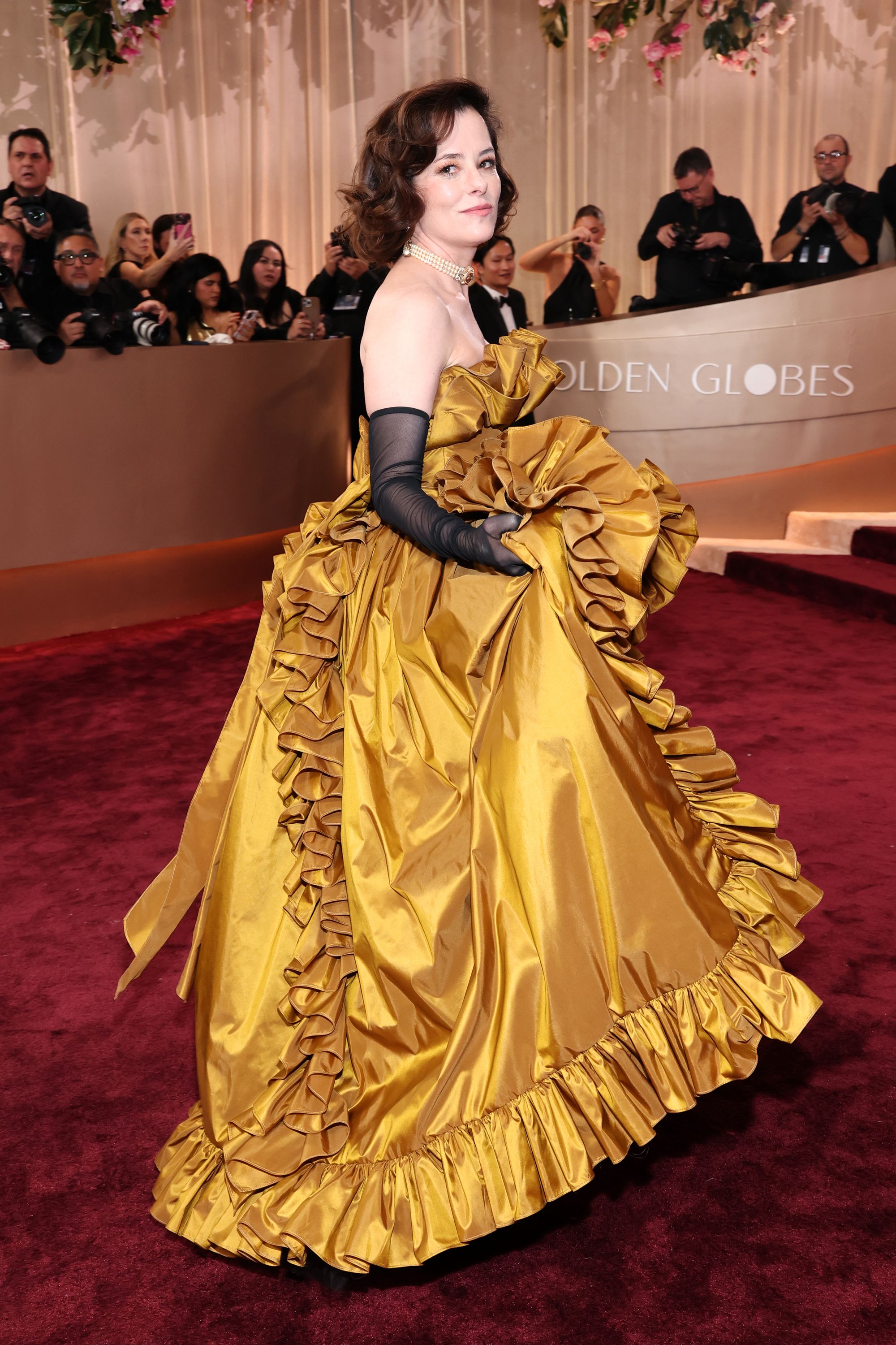 Parker Posey made a statement on the red carpet while decked out in a gold frock covered in ruffles. However, the shape was confusing and needed a tighter silhouette