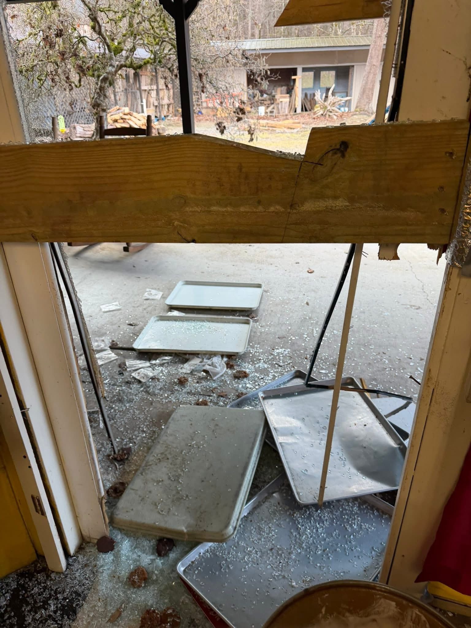 Smashed glass and trays on the pavement from inside the candy store