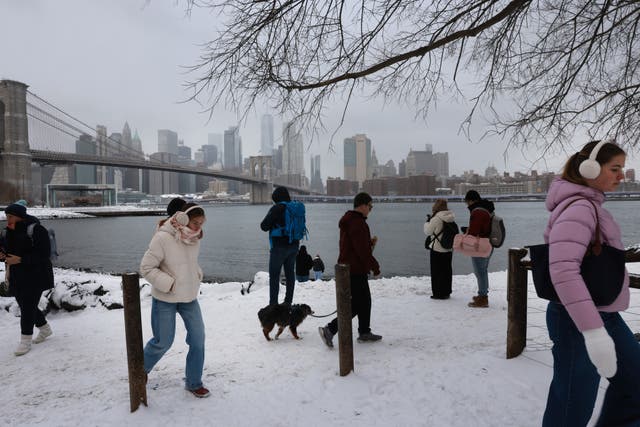 <p>People walk through the snow in Brooklyn after an overnight storm</p>