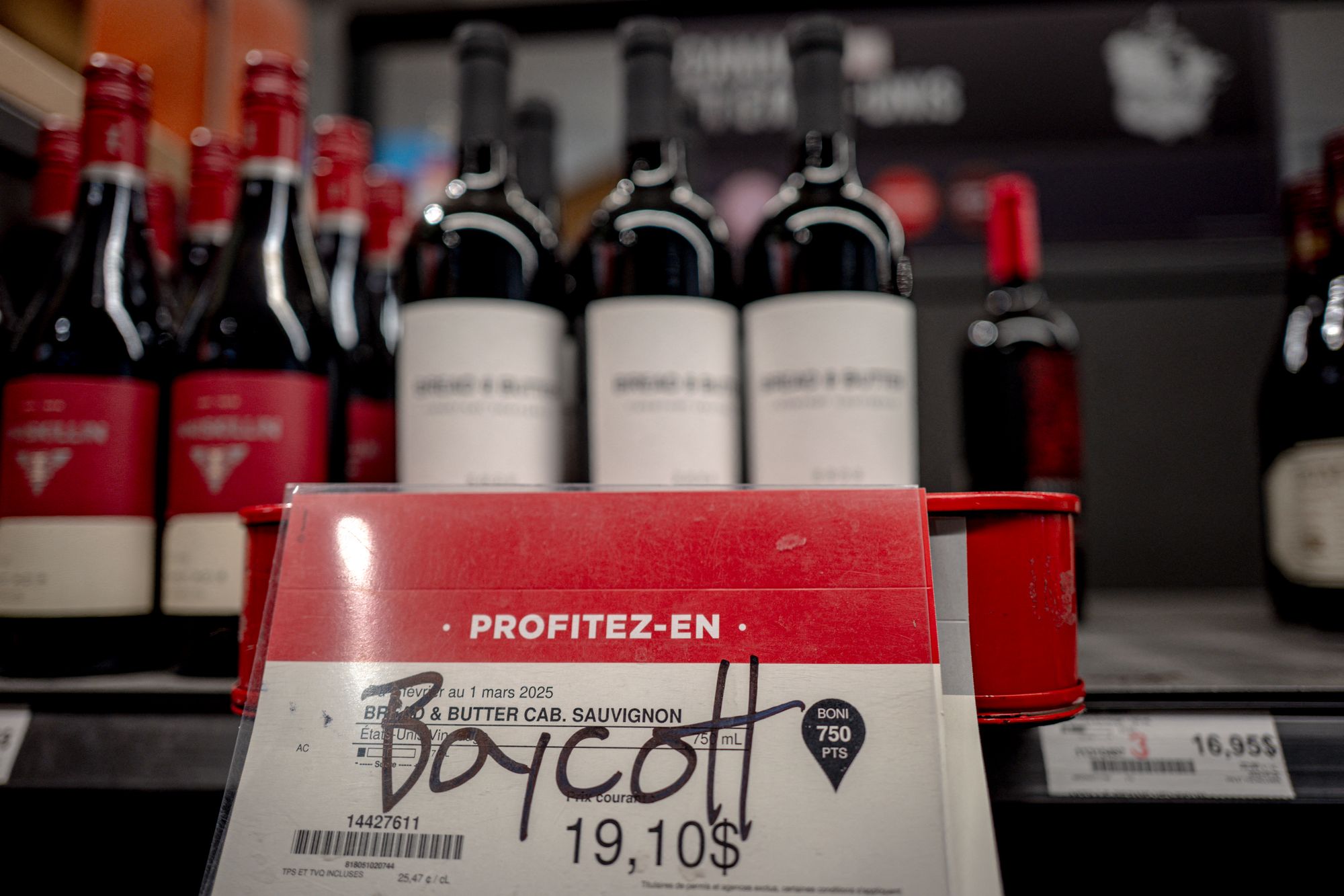 <p>Grafitti calling for a boycott on American wine at a liquor store in Montreal, Canada</p>