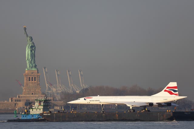 <p>Grounded: A retired British Airways Concorde being moved by a barge past the Statue of Liberty in New York City in 2024</p>