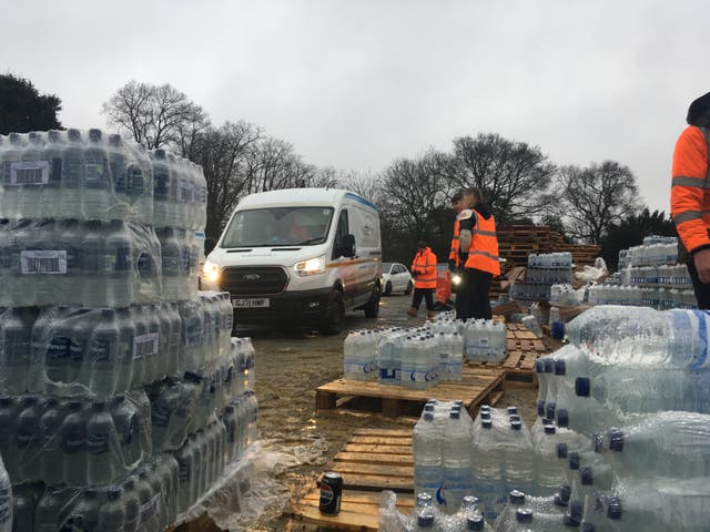 <p>Water distribution at Tunbridge Wells, where workers said around 1,000 cars an hour were arriving to collect bottled water</p>
