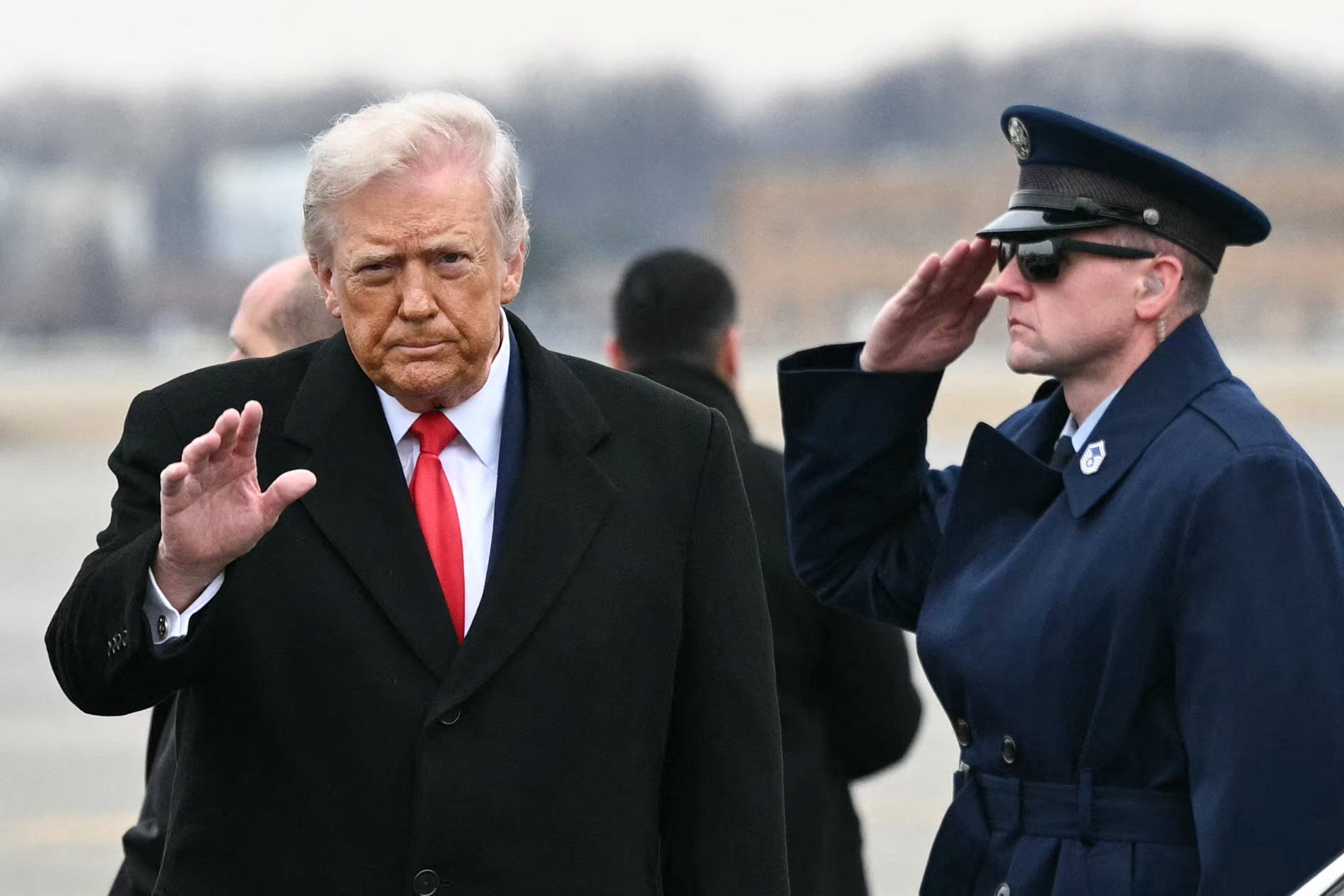 US President Donald Trump waves as he steps off Air Force One upon arrival at Detroit Metropolitan Wayne County Airport in Romulus, Michigan, on January 13, 2026