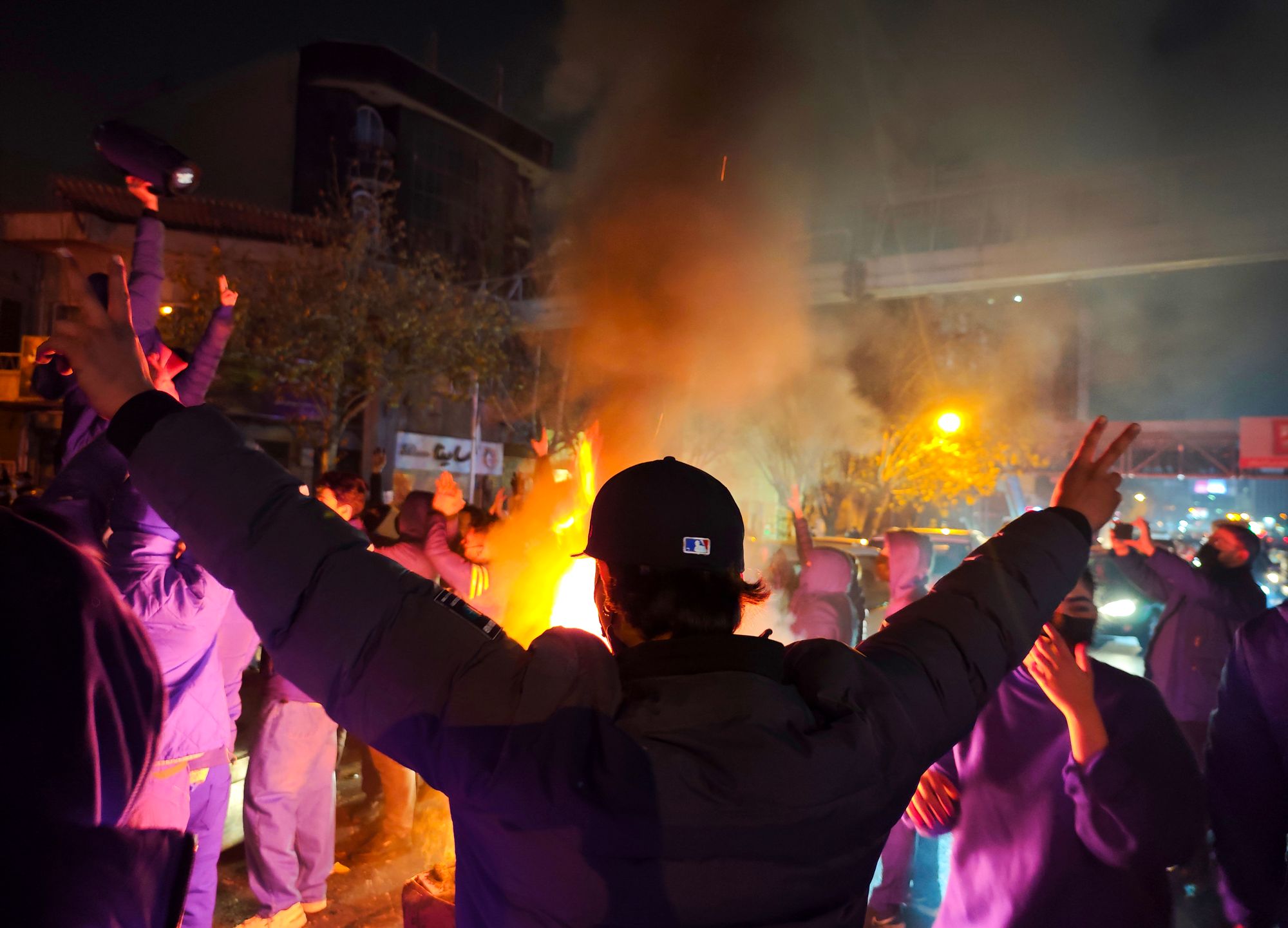 Fires are lit as protesters rally on 8 January 2026 in Tehran, Iran