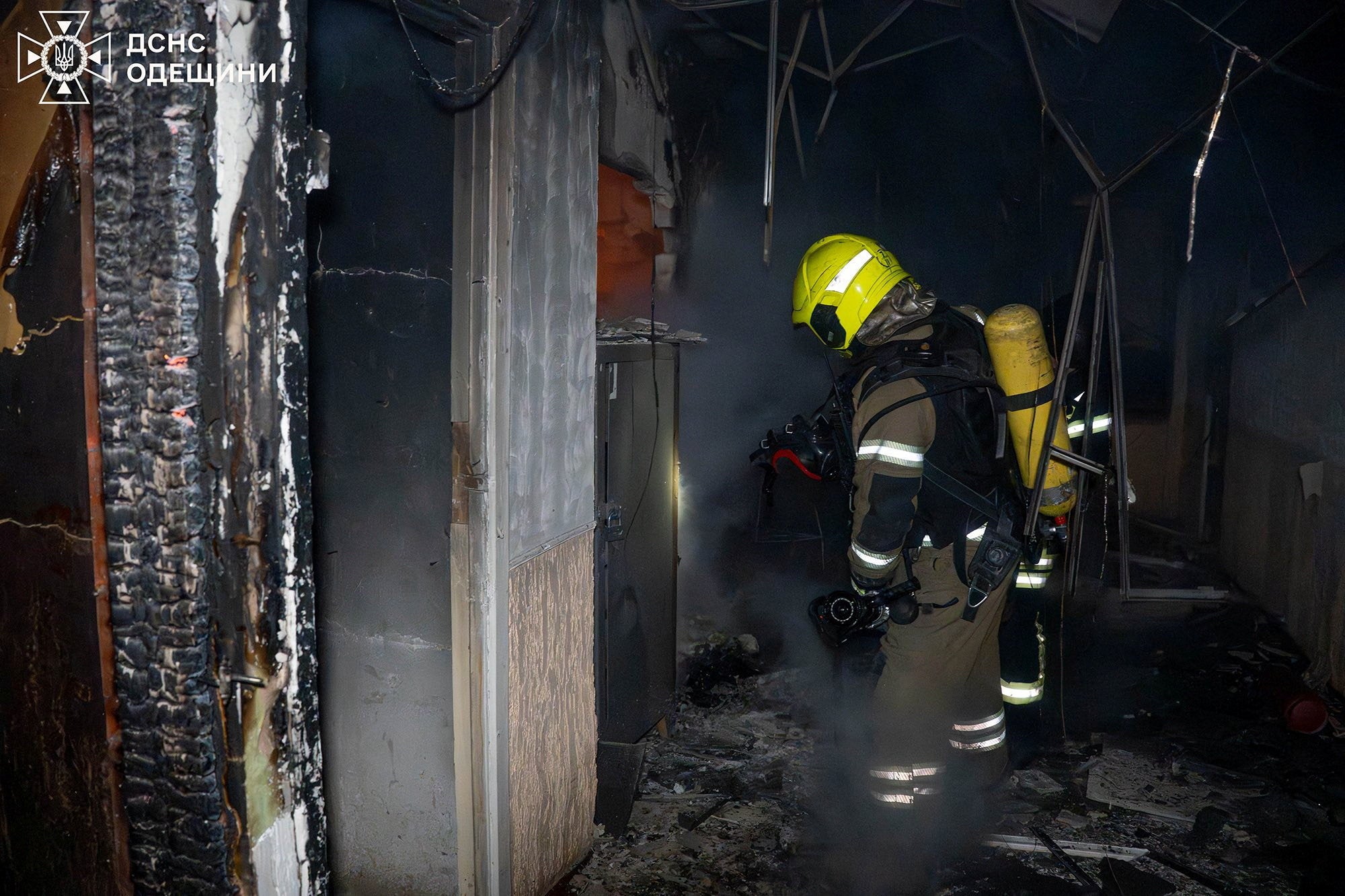 A firefighter inspects damage at a site of a Russian drone strike in Odesa