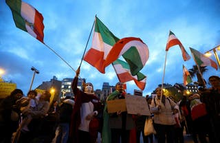 People wave flags during a demonstration in support of the national protests in Iran, in Barcelona