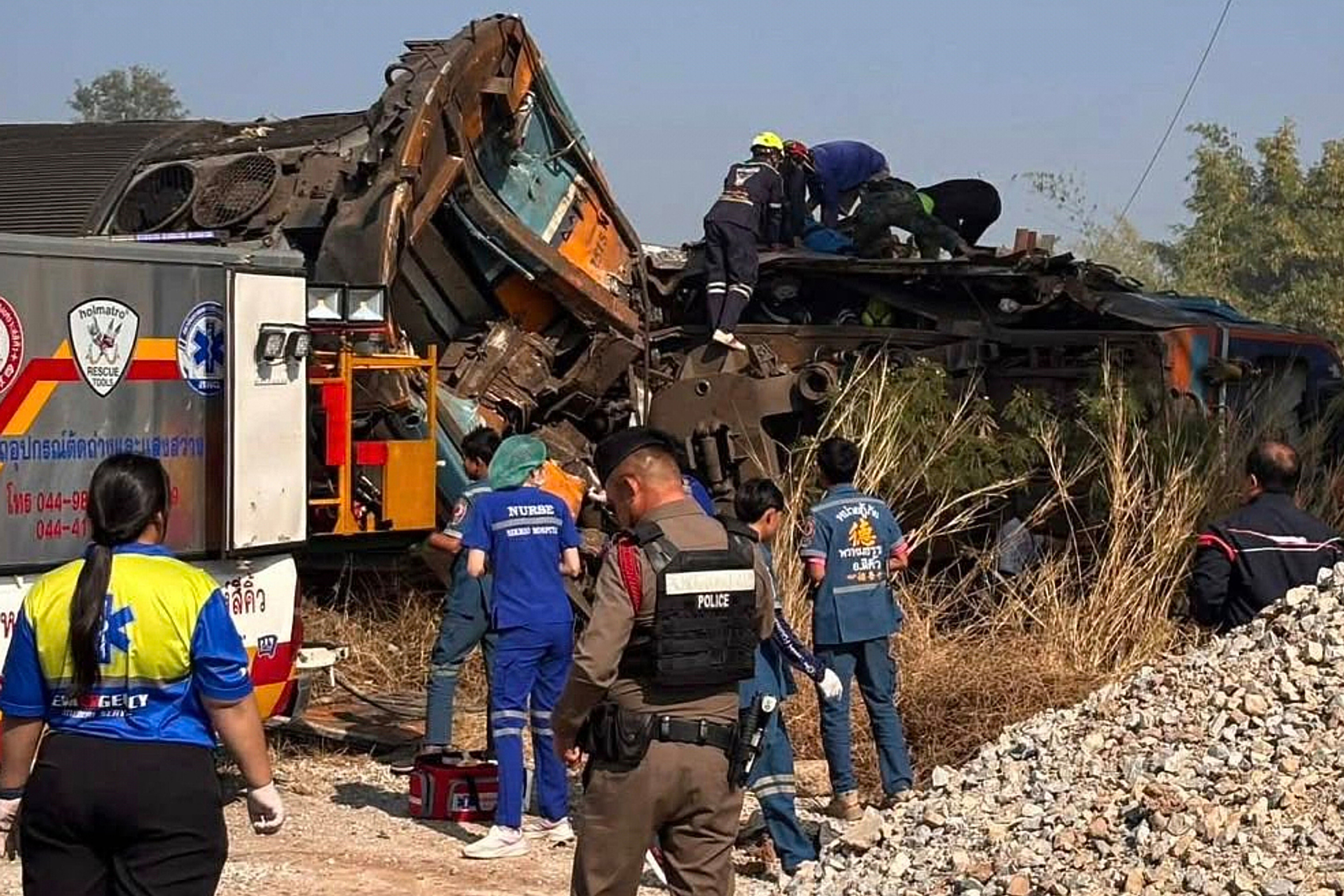 Aid workers after a construction crane fell into a passenger train in Nakhon Ratchasima province