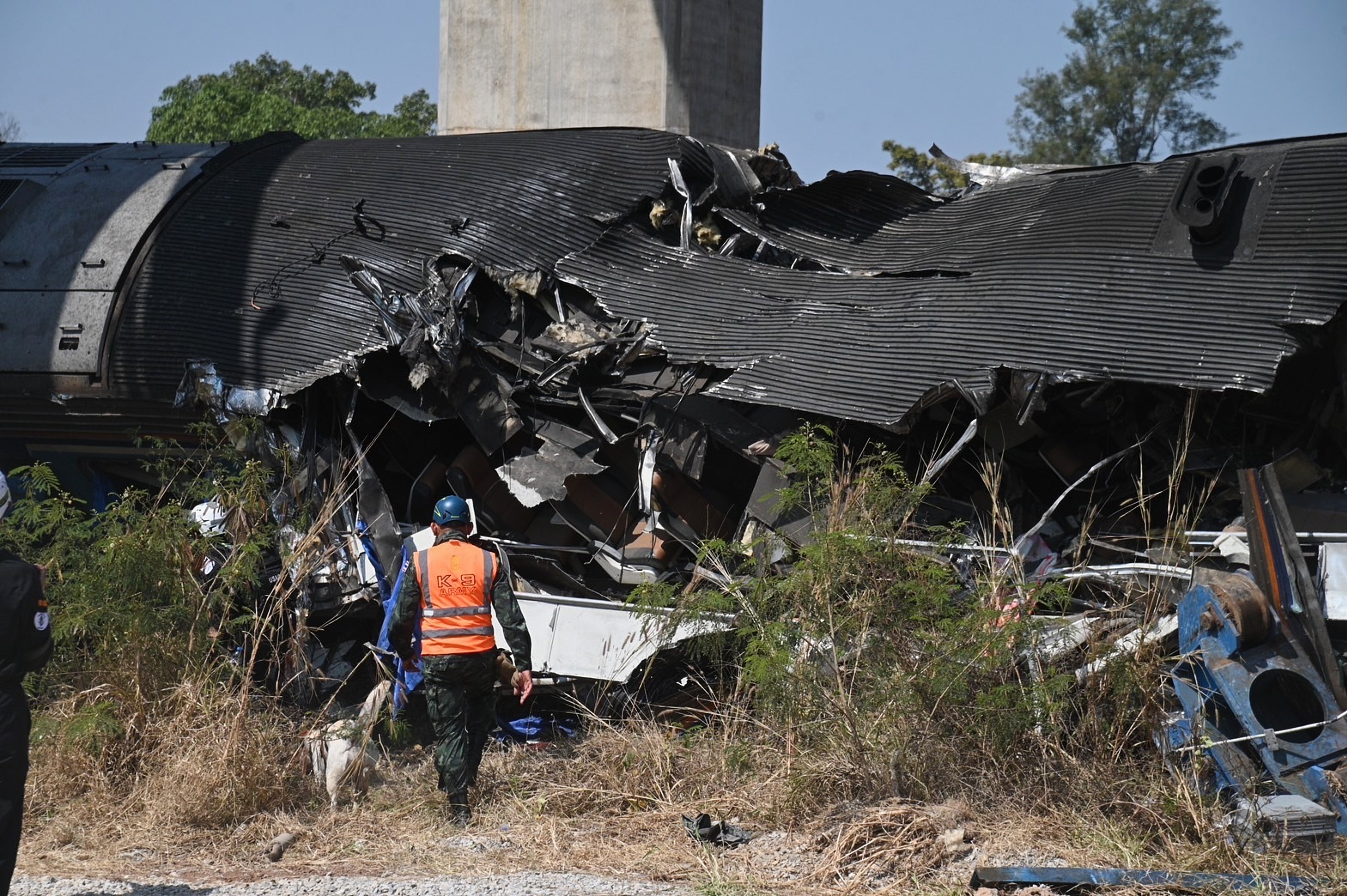 An aid workers at the scene after a construction crane fell into a passenger train in Nakhon Ratchasima province, Thailand