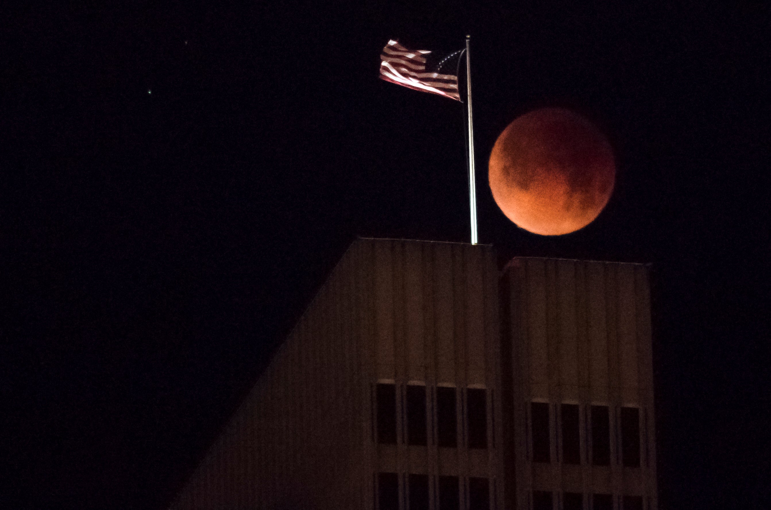 A blood moon is seen over a building in San Francisco, California, in January 2018