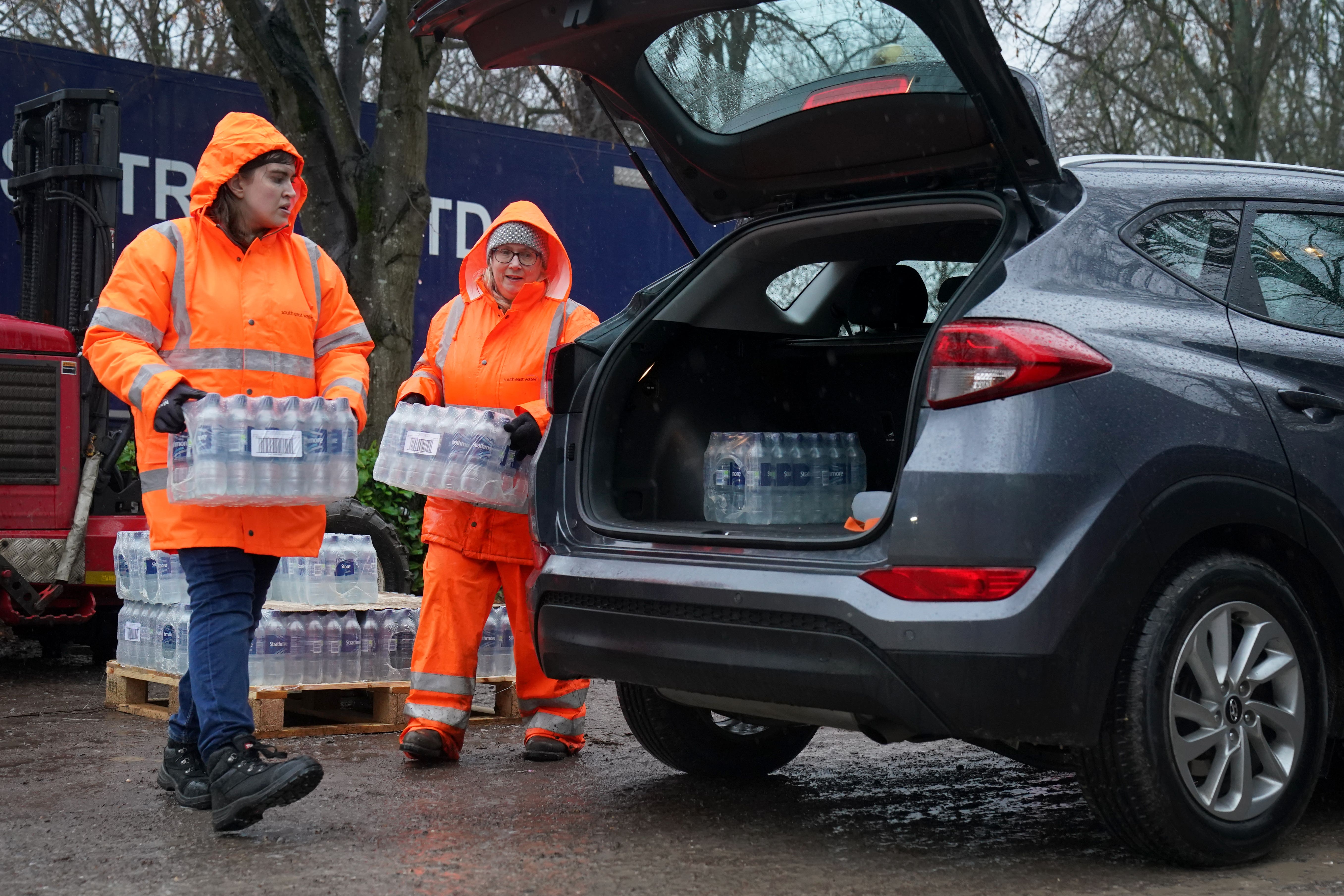 South East Water staff hand out bottled water at a water station in Maidstone, after bad weather was blamed for more water outages in Kent and parts of Sussex (Gareth Fuller/PA)