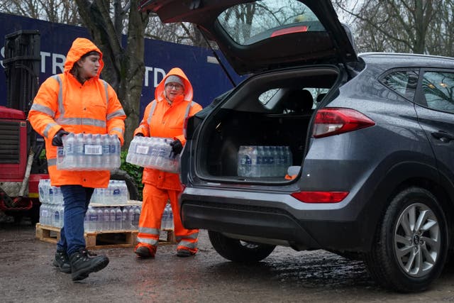 South East Water staff hand out bottled water at a water station in Maidstone, after bad weather was blamed for more water outages in Kent and parts of Sussex (Gareth Fuller/PA)