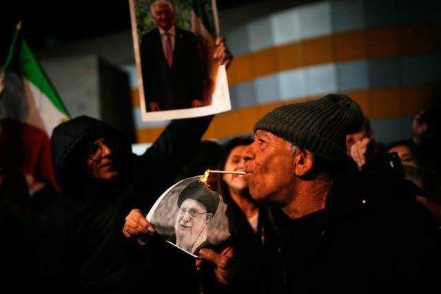 <p>A demonstrator lights a cigarette with a burning poster depicting Supreme Leader Ayatollah Ali Khamenei during a rally in support of Iran's anti-government protests, in Holon, Israel Wednesday, Jan. 14, 2026. (AP Photo/Ohad Zwigenberg)</p>