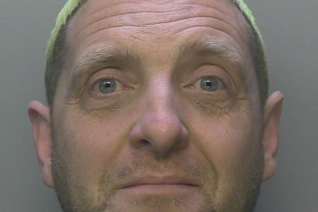 <p>Robert Rhodes, 52, who stabbed to death his wife while chillingly manipulating their young child in a plot to try to get away with murder, has been jailed (Surrey Police/PA)</p>