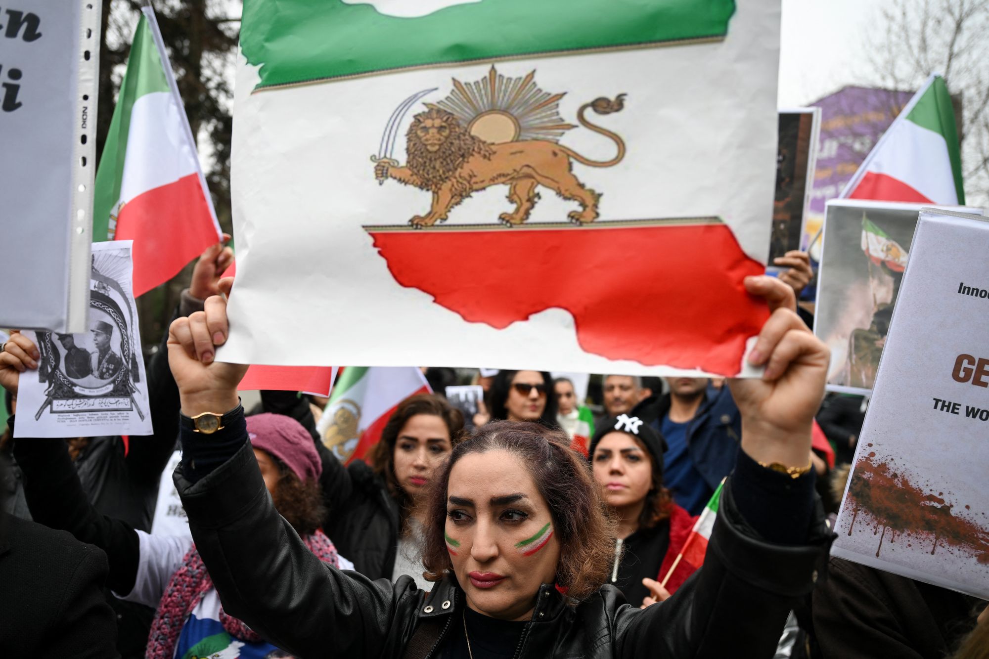 An Anti-Iranian regime protester holds a flag of Iran from before the 1979 revolution, with the lion ad sun emblems, during a demonstration in solidarity with Iranian protestors and "against the Islamic Repuplic for killing Iranian people" in Yalova, on January 16, 2026.