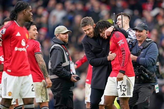 <p>Michael Carrick embraces Patrick Dorgu after the full-time whistle</p>