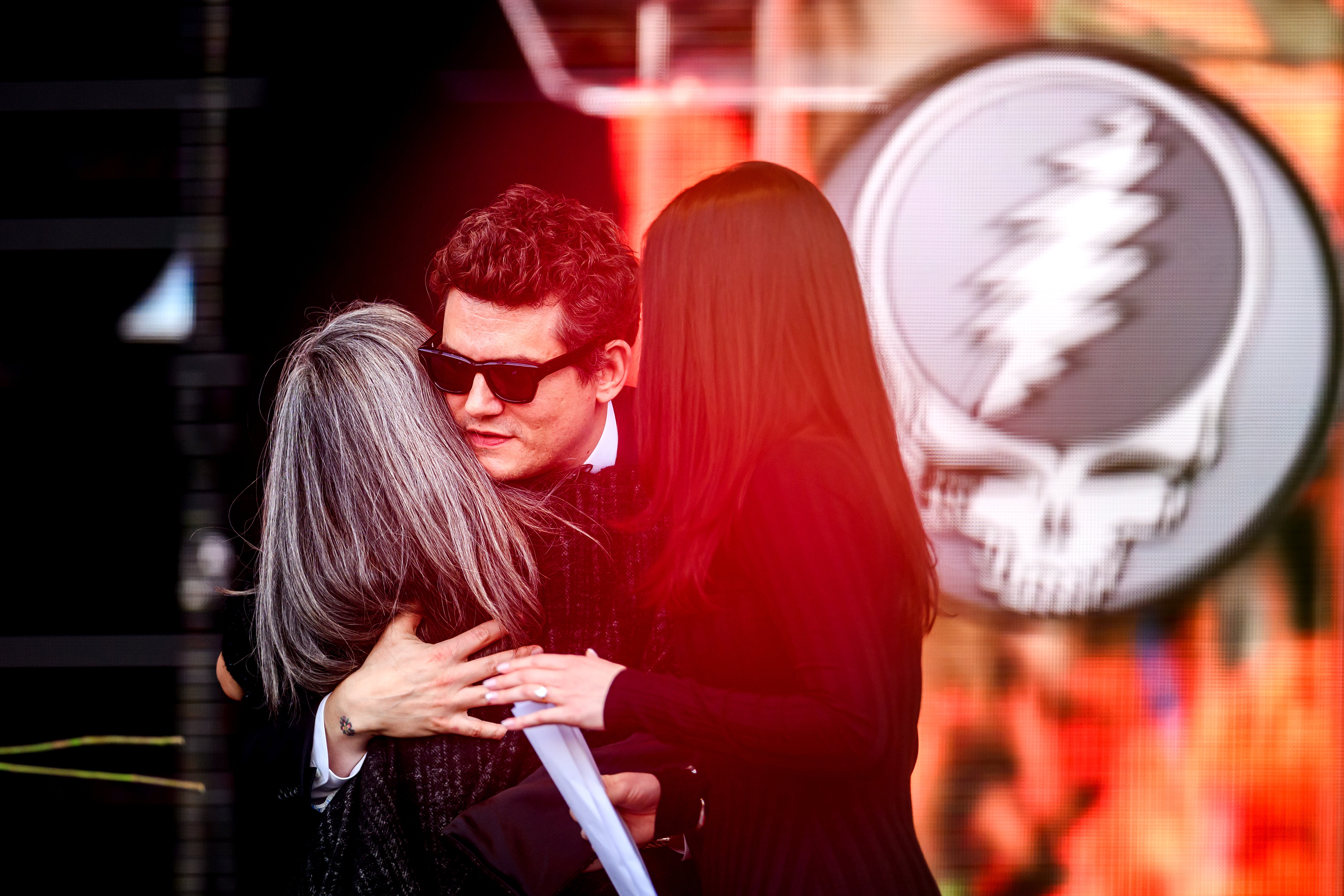 Joan Baez and John Mayer spoke on a makeshift stage in front of the Bill Graham Civic Auditorium after four Buddhist monks opened the event with a prayer