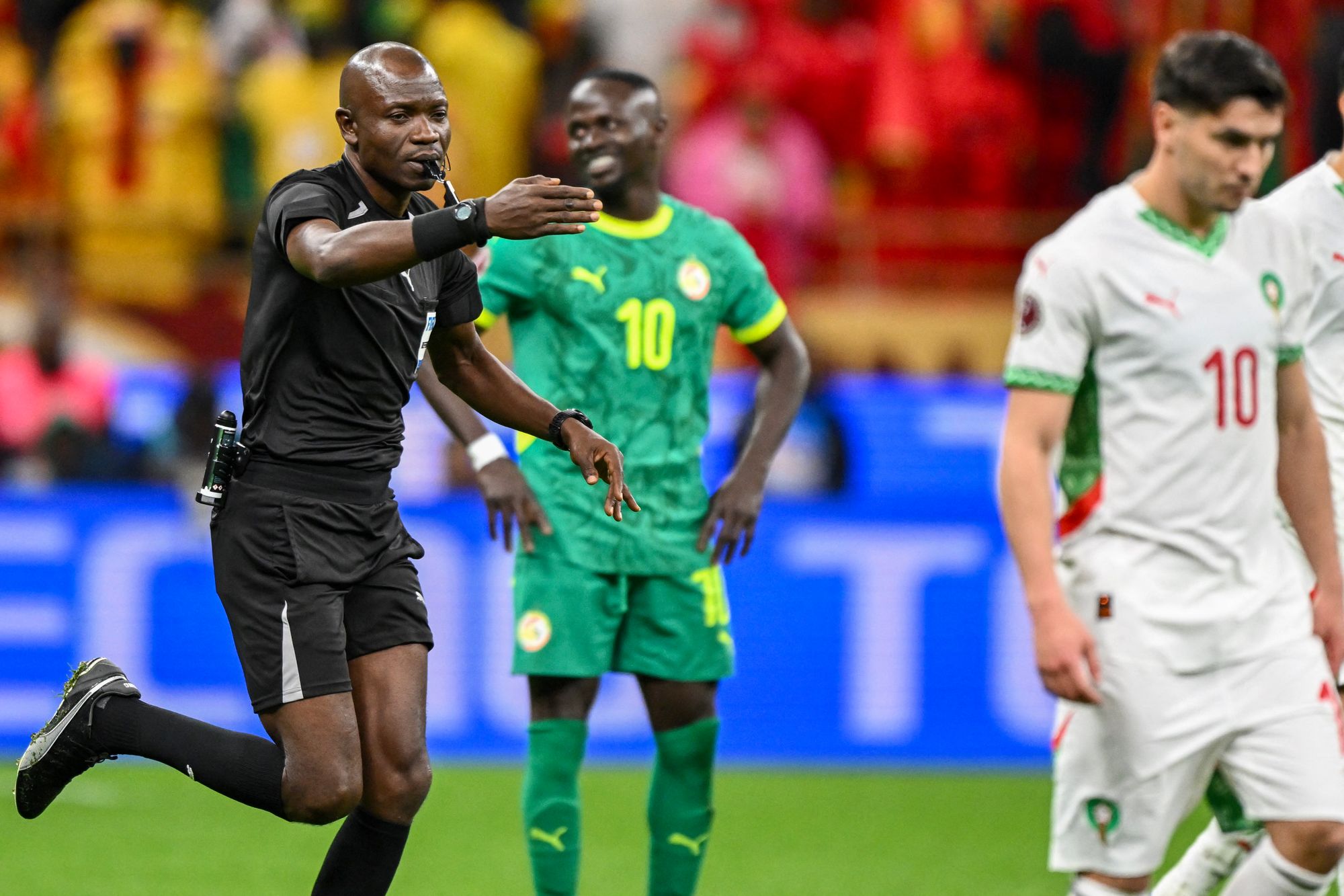 Jean-Jacques Ndala points to the spot to award Morocco a controversial late penalty