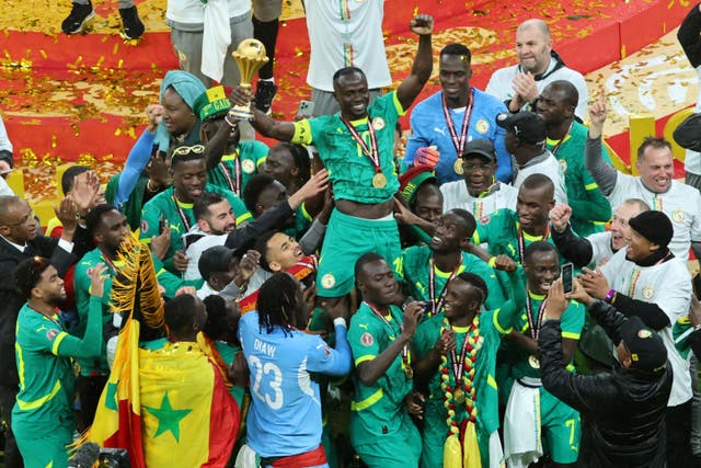 Senegalese players celebrate after winning the Africa Cup of Nations (Youssef Loulidi/AP)