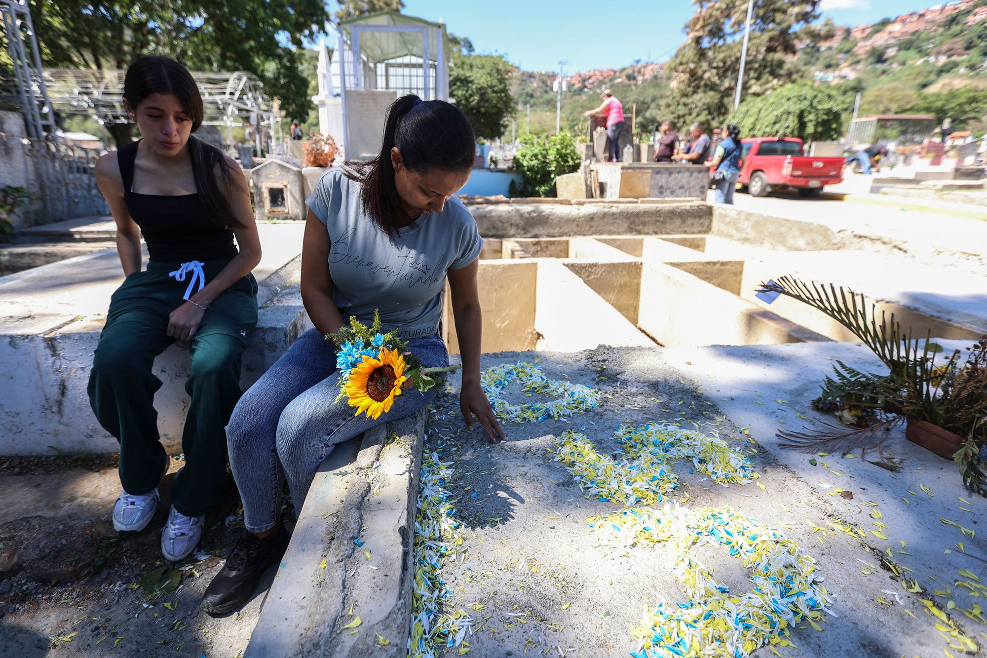 Natividad Martinez lays flowers in her son’s memory