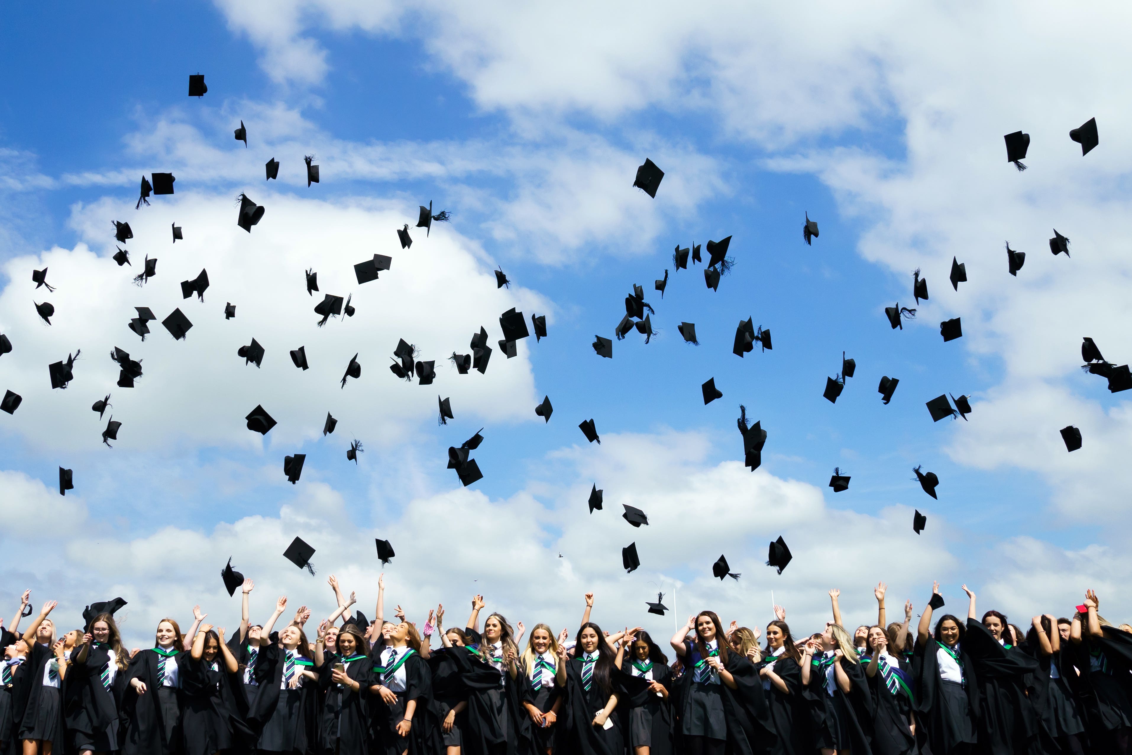 Students throw their mortarboards into the air following a graduation ceremony (Danny Lawson/PA)