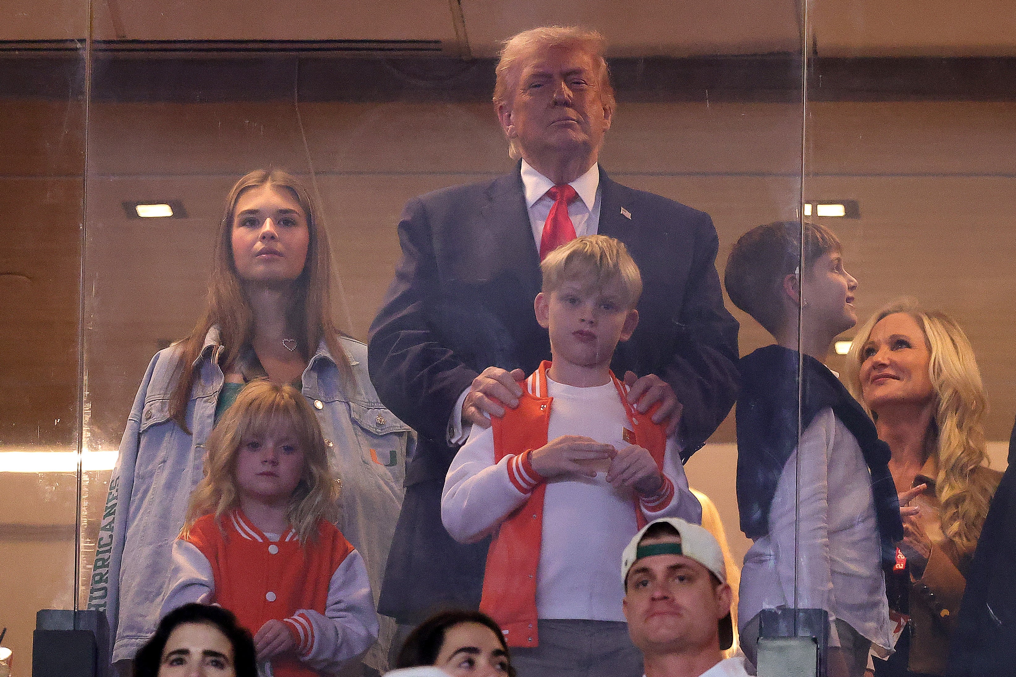 President Donald Trump, accompanied by his eldest daughter Ivanka and granddaughter Kai, got a thunderous reception at the College Football Playoff national championship game in Miami Monday night
