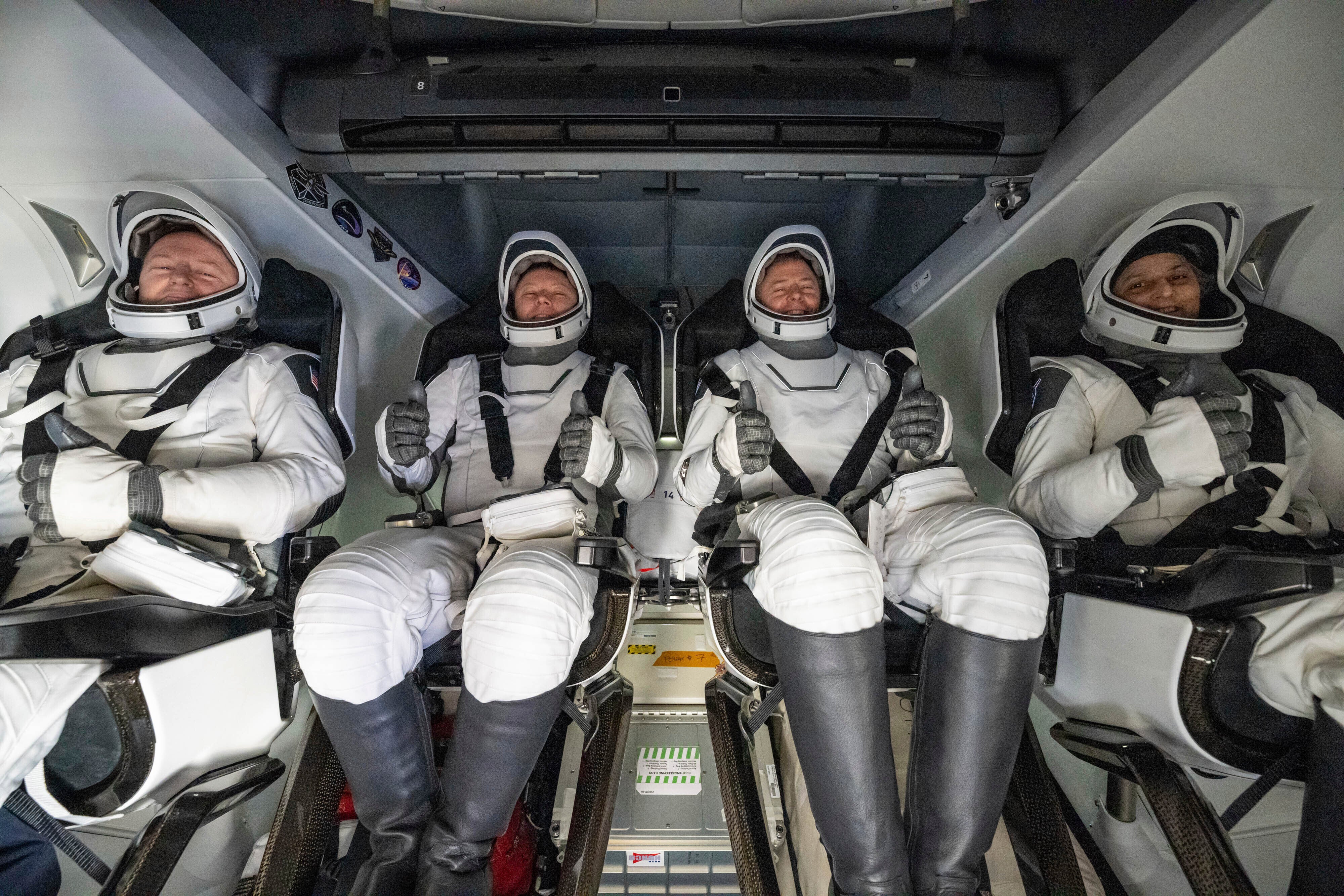 From left, NASA astronaut Butch Wilmore, Russia's Alexander Gorbunov, and NASA astronauts Nick Hague and Suni Williams sit inside a SpaceX capsule onboard the SpaceX recovery ship Megan after landing in the water off the coast of Florida, March 18, 2025. (Keegan Barber/NASA via AP, File)