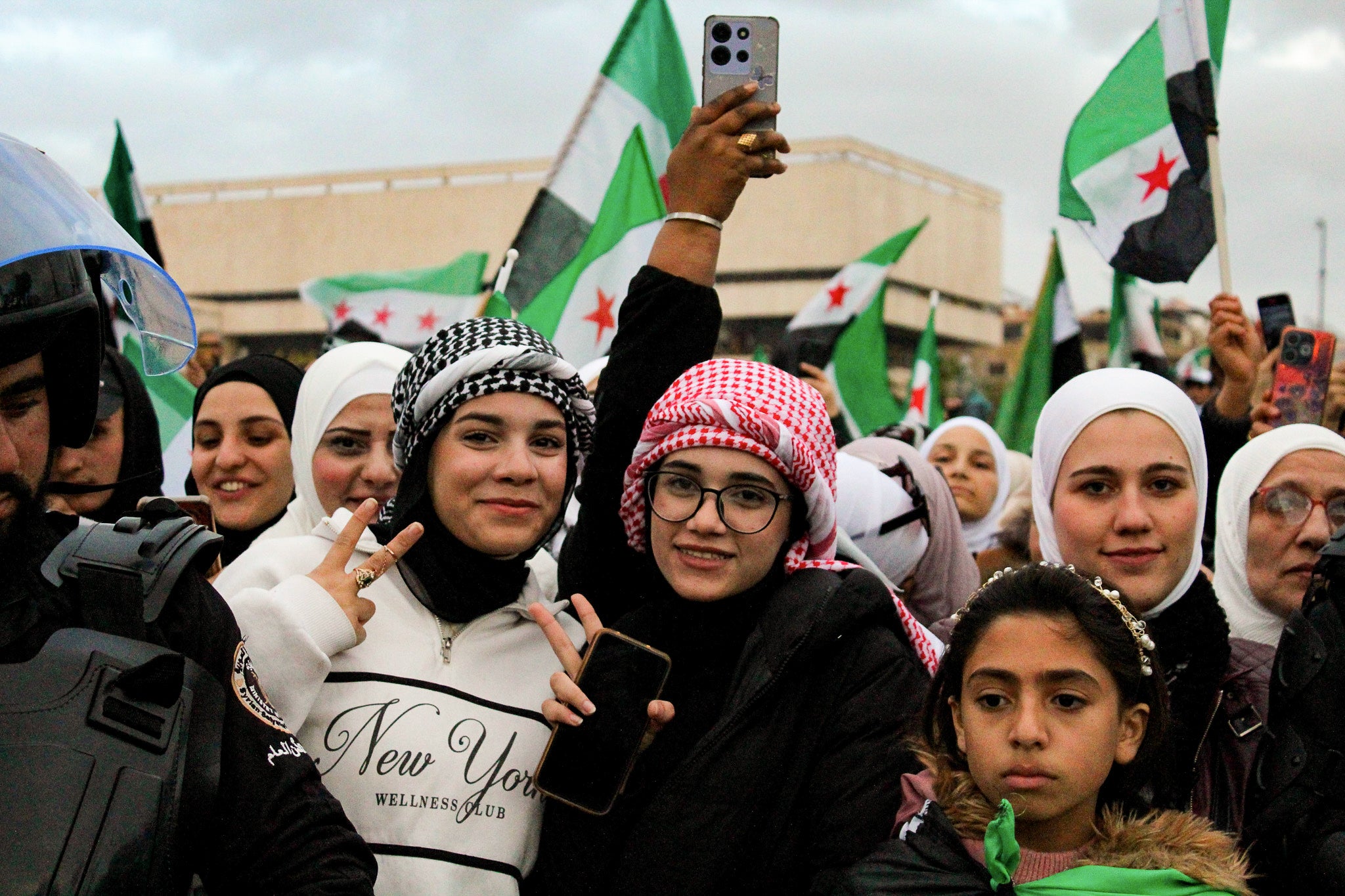 <p>Women and girls in the crowd during celebrations to mark the one year anniversary of the fall of the Assad regime in central Damascus</p>