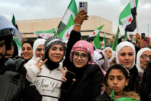 <p>Women and girls in the crowd during celebrations to mark the one year anniversary of the fall of the Assad regime in central Damascus</p>