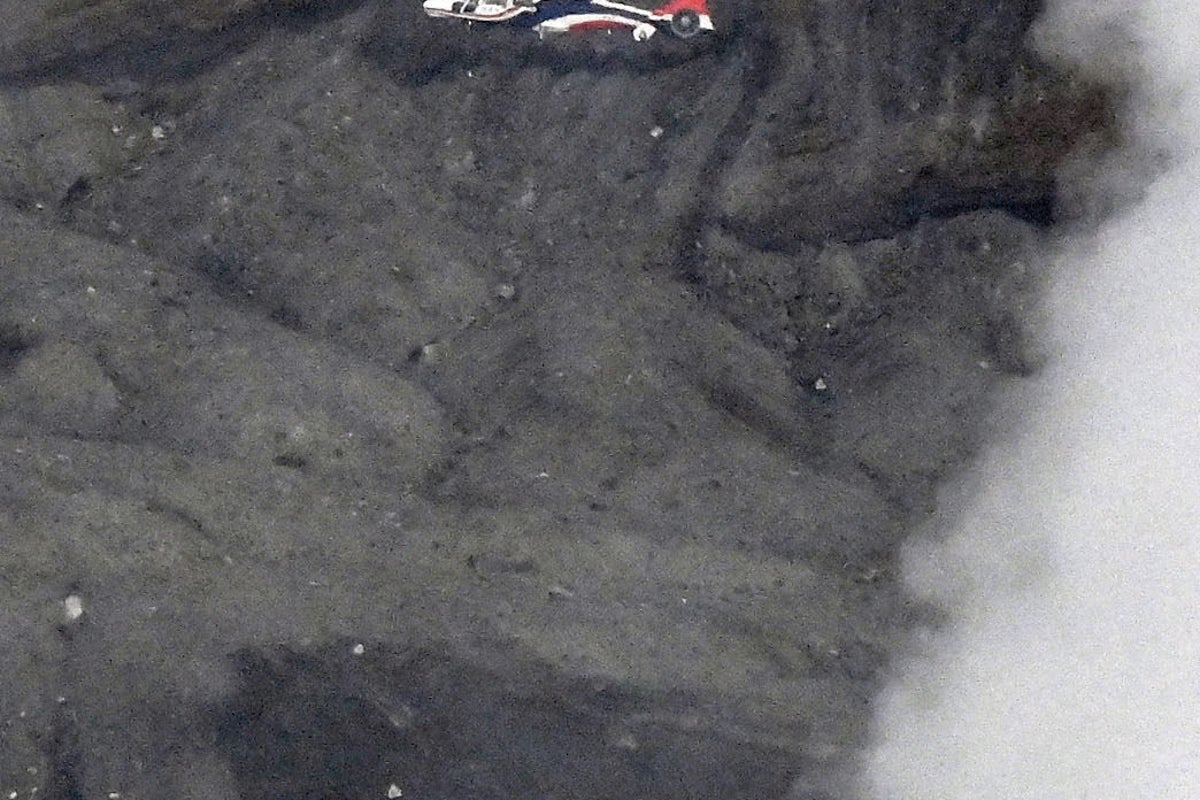Rescuers spot wreckage possibly from a helicopter that went missing near a volcano in Japan
