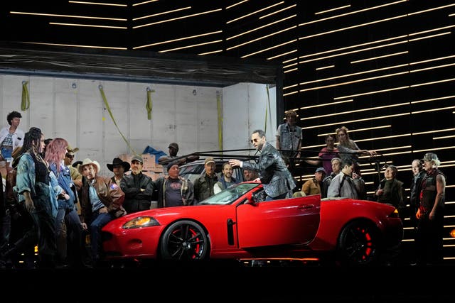 <p>This image released by the Metropolitan Opera shows bass-baritone Kyle Ketelsen, in the red car, during a rehearsal of Bizet’s ‘Carmen’ at the Metropolitan Opera in New York on Dec. 28, 2023. (Ken Howard/Met Opera via AP)</p>
