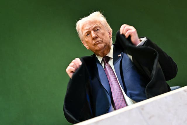 <p>US President Donald Trump adjusts his jacket as he leaves the Congress Centre during the World Economic Forum (WEF) annual meeting in Davos.</p>