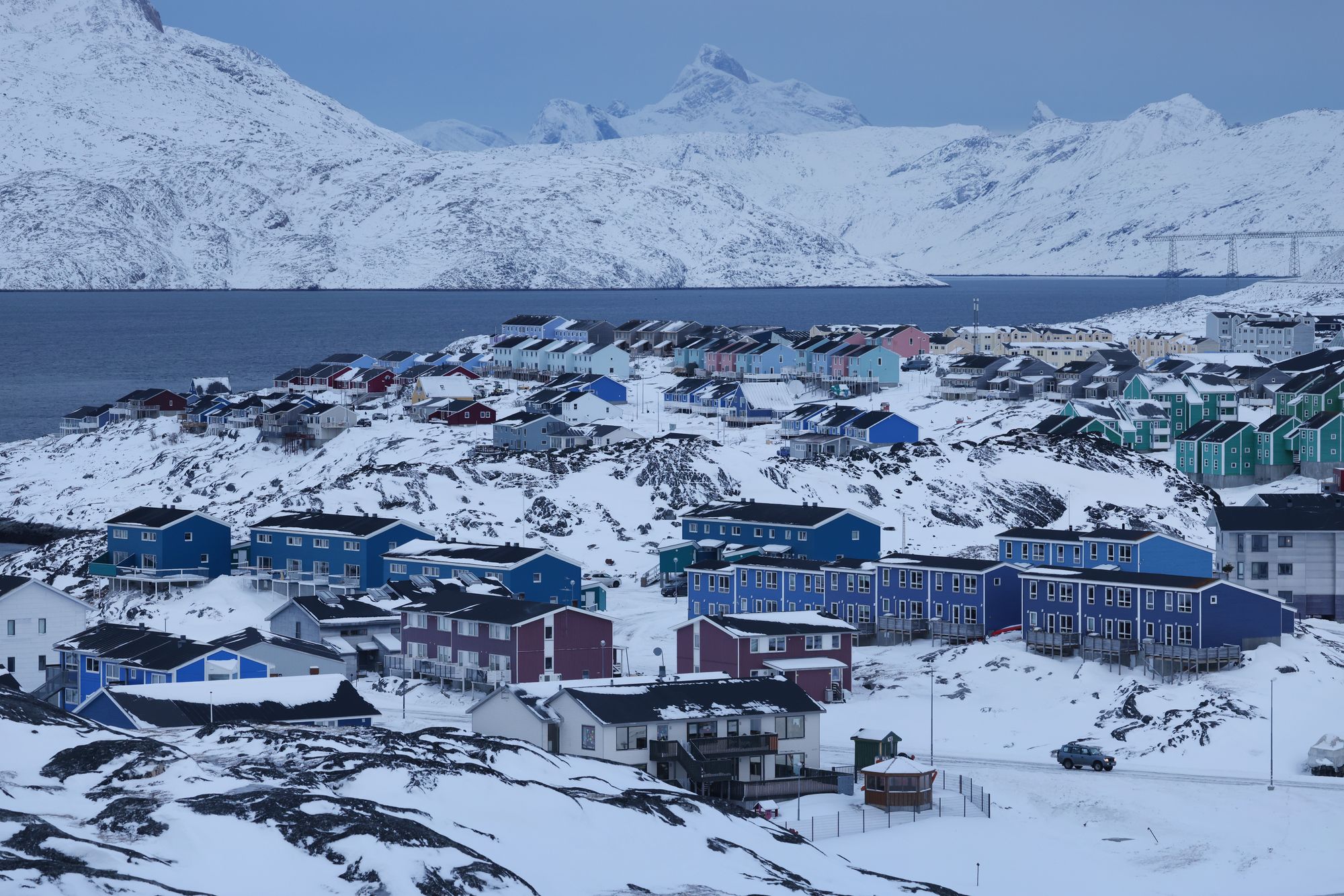 Residential apartment buildings stand among snow on January 21, 2026 in Nuuk, Greenland
