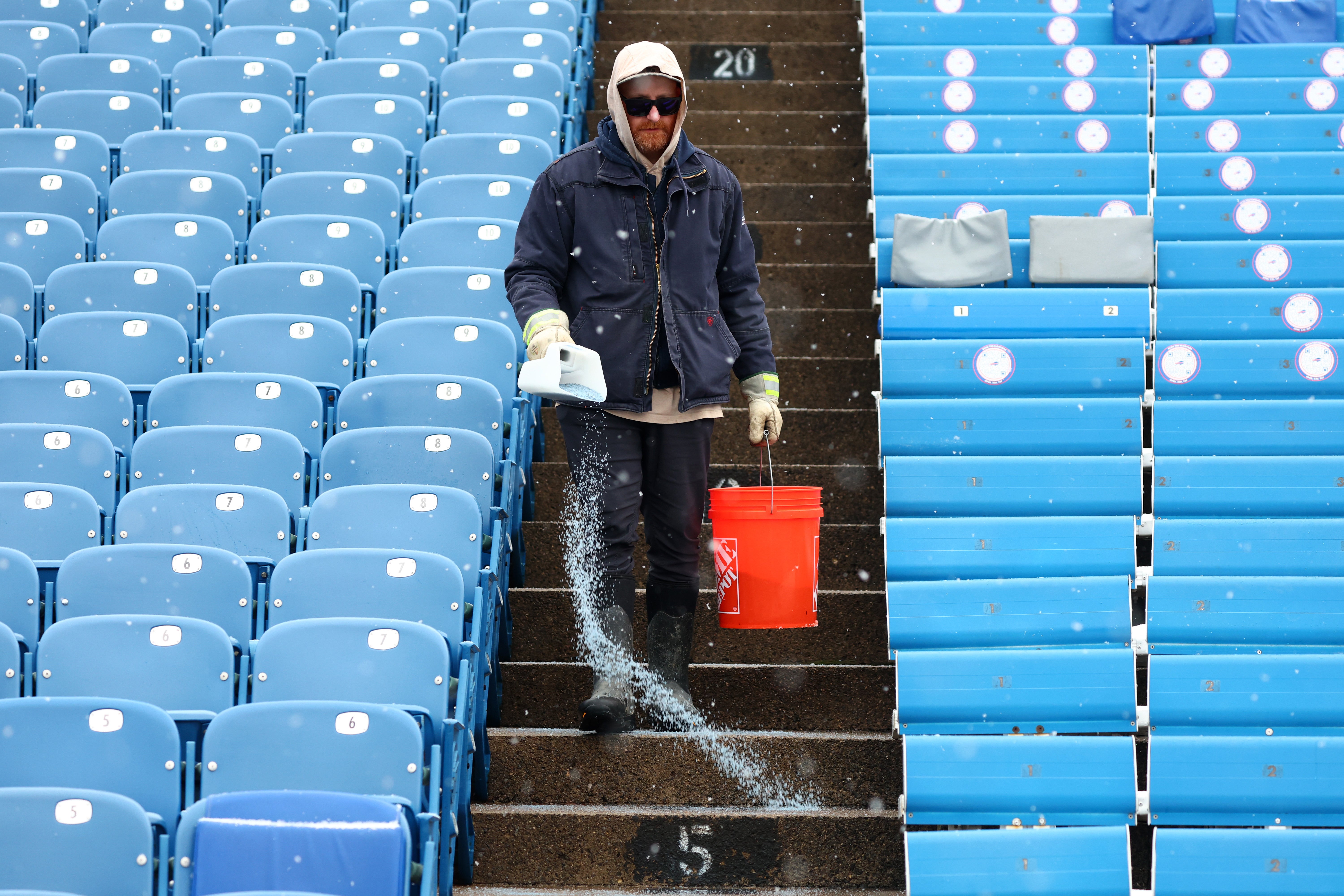 <p>Salt is applied to the steps as snow falls at Buffalo Bills Highmark Stadium before an NFL football game between the Buffalo Bills and the Cincinnati Bengals, Dec. 7, 2025, in Orchard Park, N.Y. (AP Photo/Jeffrey T. Barnes, File)</p>
