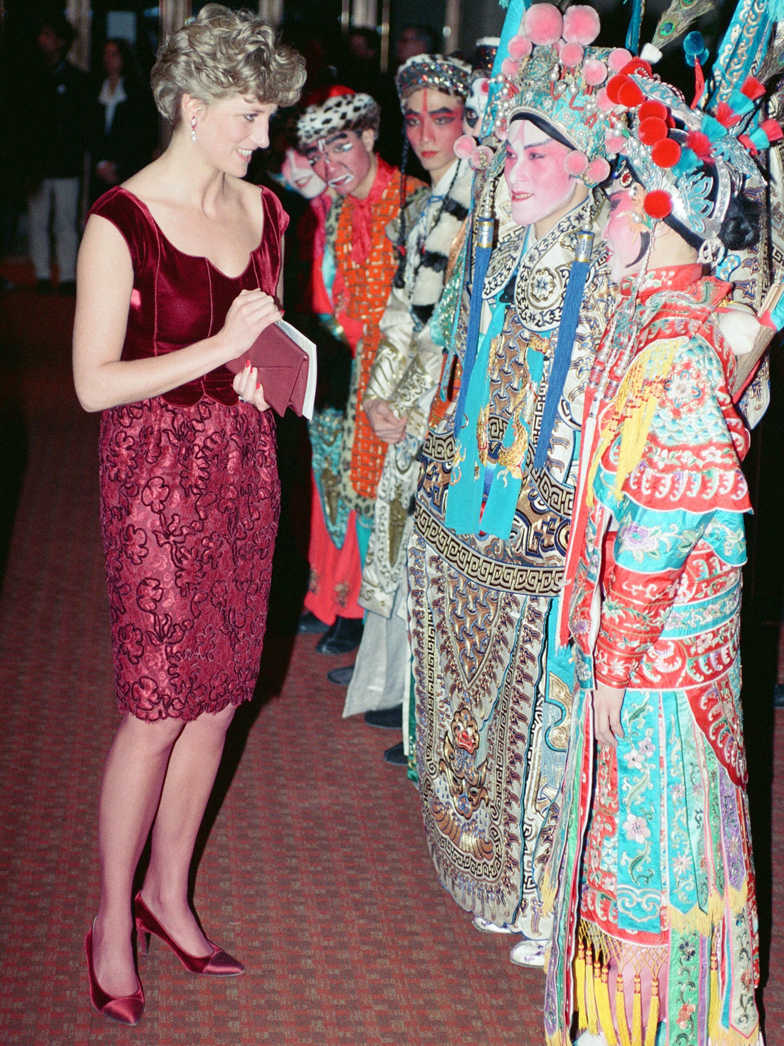 Princess Diana, Princess of Wales, wearing Valentino, meets the cast of The Hong Kong Gala at The Barbican Centre in London on 23 January 1992