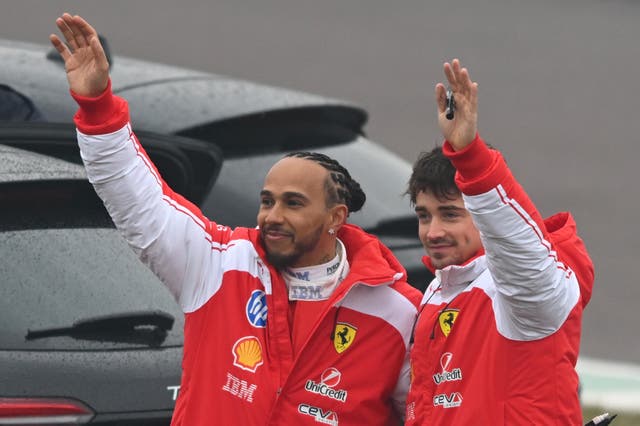 <p>Lewis Hamilton and Charles Leclerc wave to the crowd in Fiorano on Friday</p>