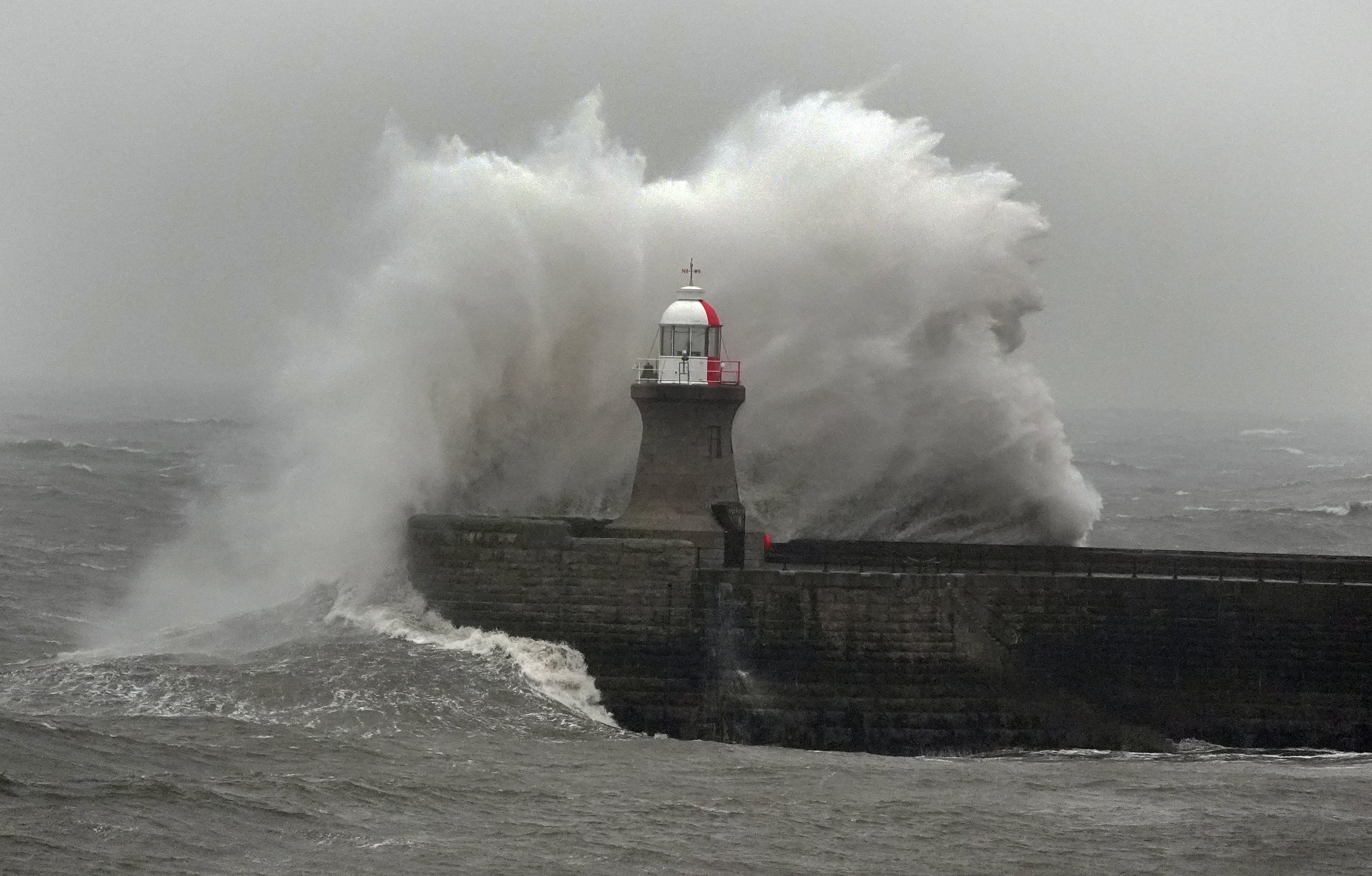 Waves crash against South Shields lighthouse on the North East coast