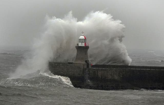 <p>Waves crash against South Shields lighthouse on the North East coast</p>