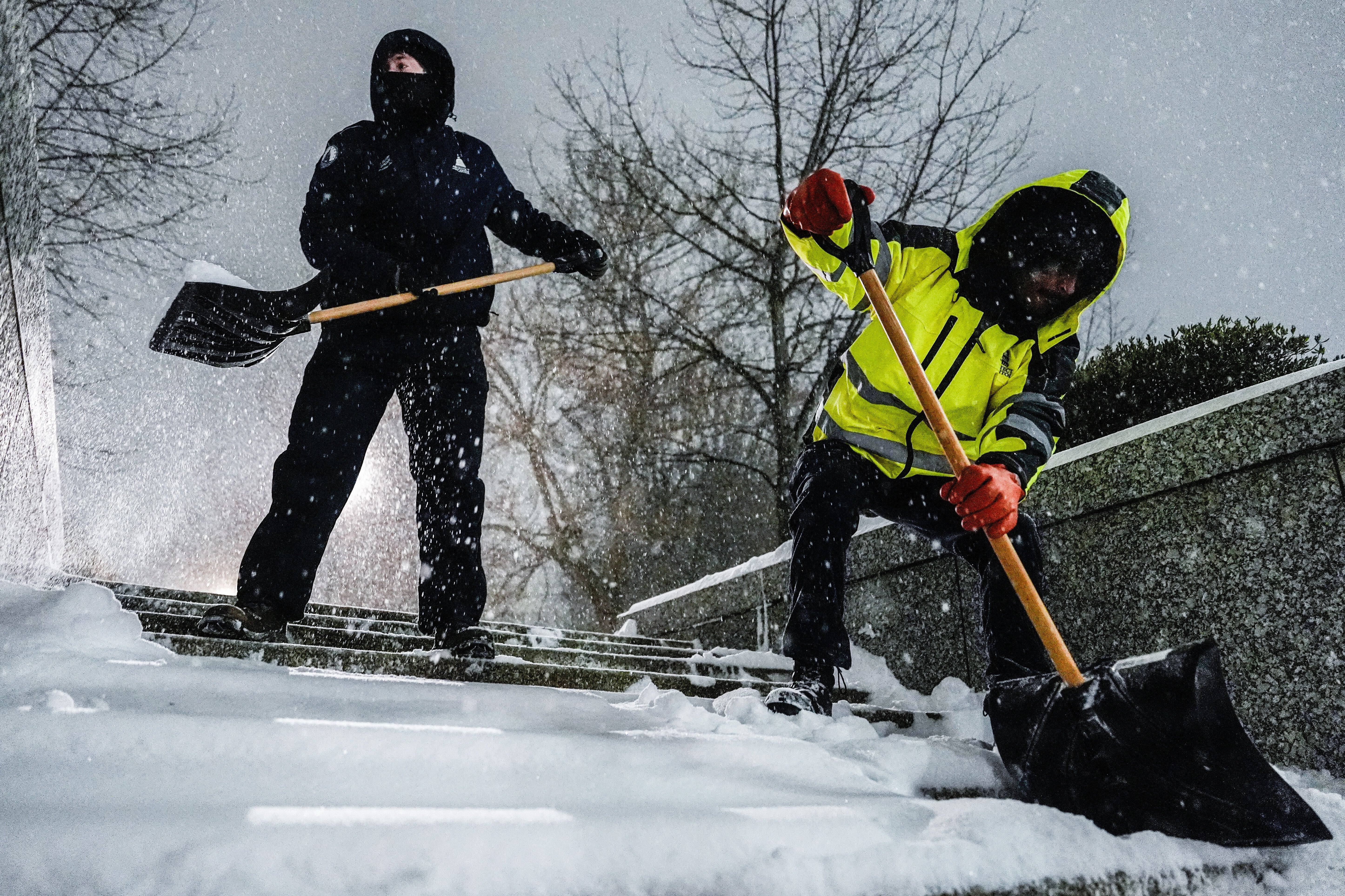 Workers shovel snow near the U.S. Capitol on Sunday