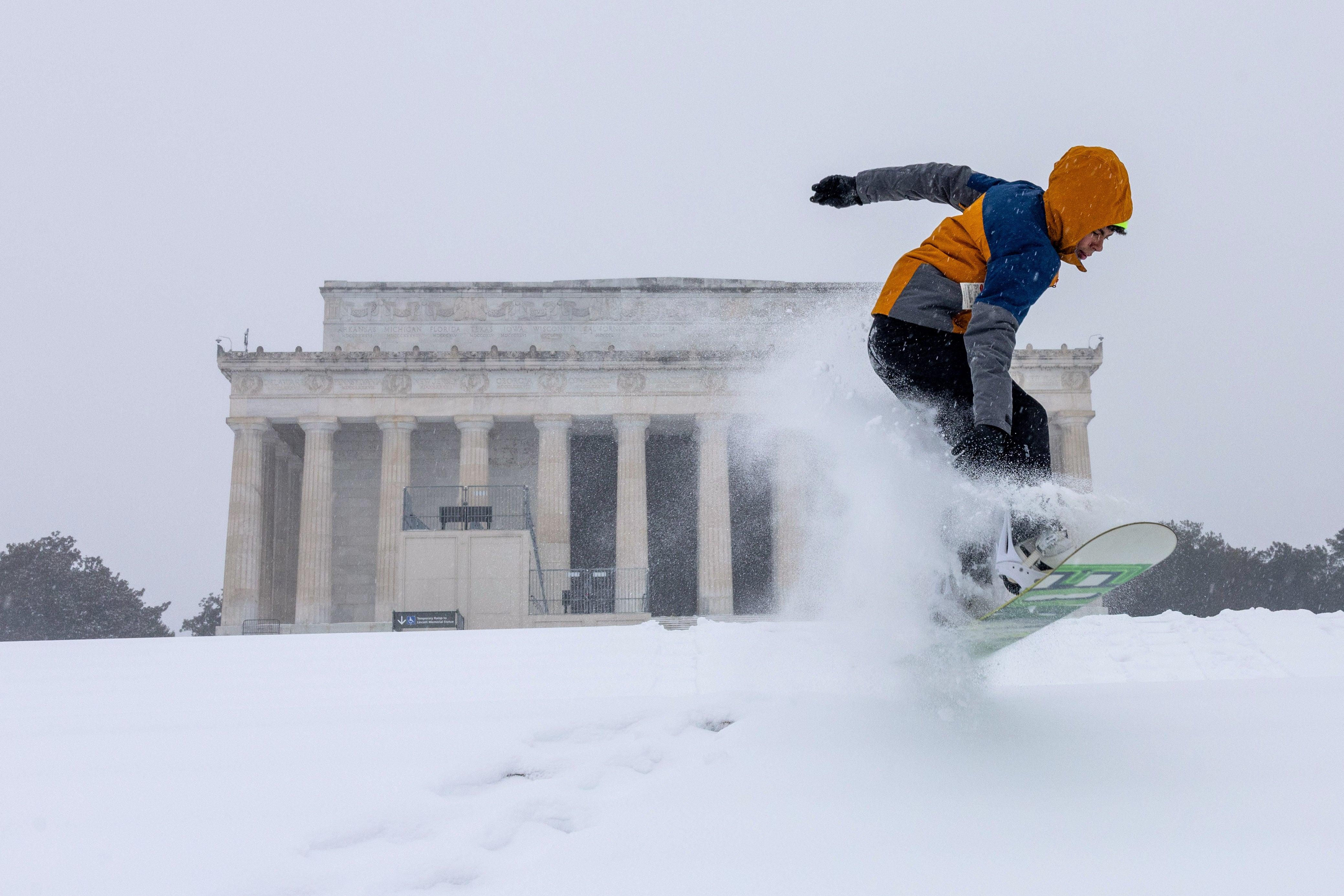 Families also flocked to Capitol Hill, where children gleefully sledded down the steep slopes below the iconic white-domed US Congress building