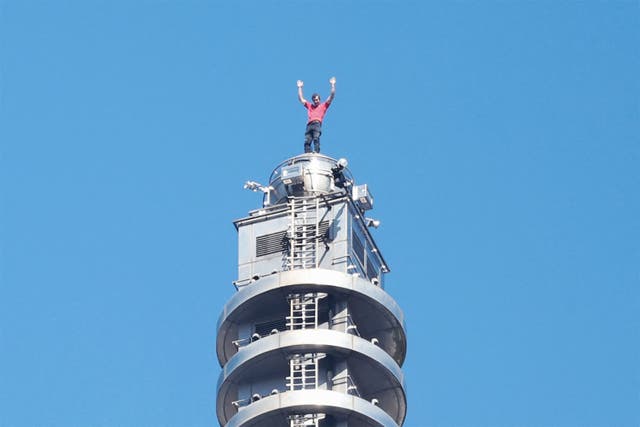 <p>US rock climber Alex Honnold on top of the Taipei 101 building </p>