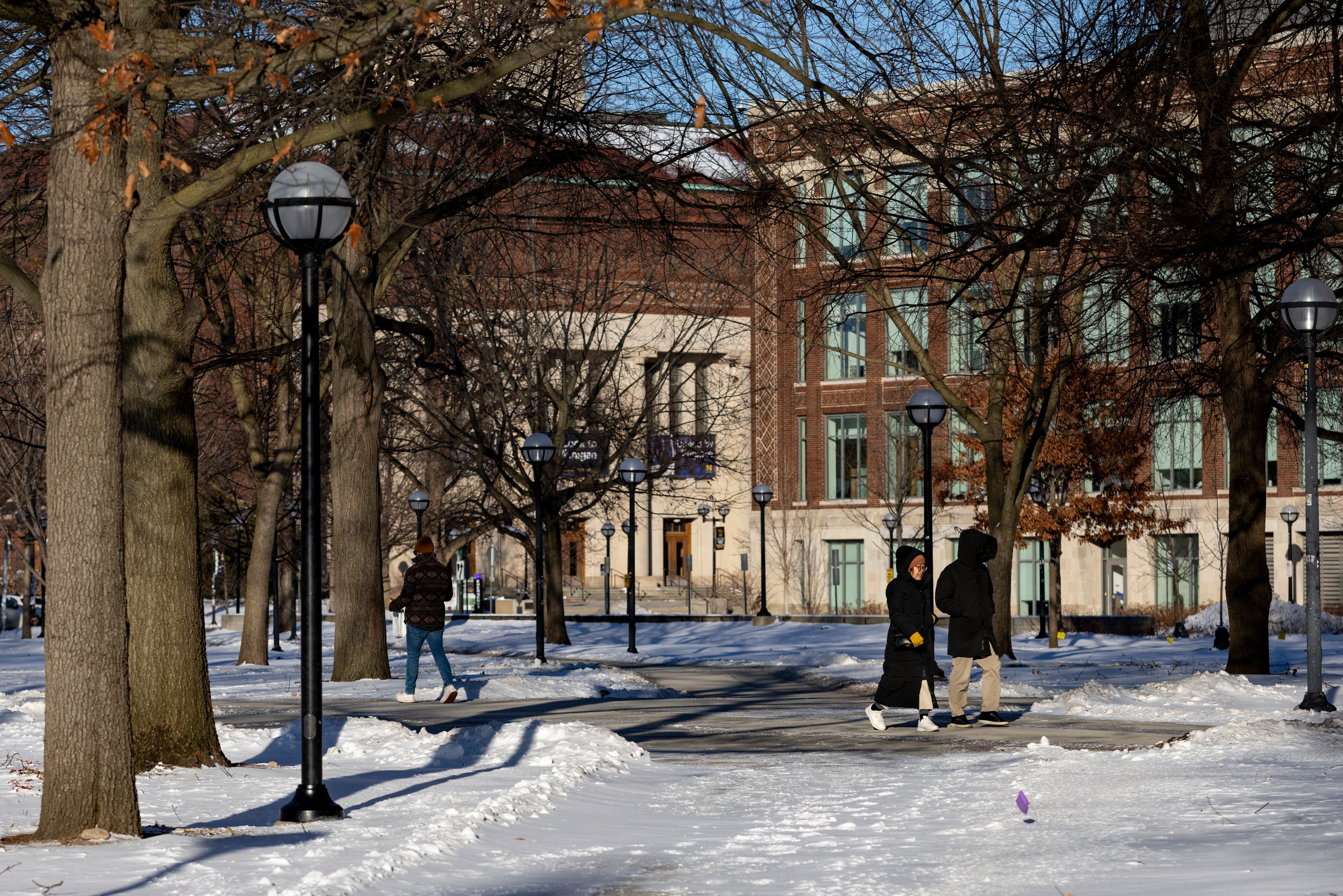 <p>People walk around the University of Michigan campus in Ann Arbor, Mich., Jan. 17, 2026. (AP Photo/Emily Elconin)</p>