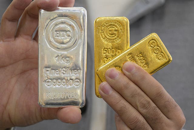 <p>A jeweller shows gold and silver bars at his shop in downtown Kuwait City on January 12, 2026</p>